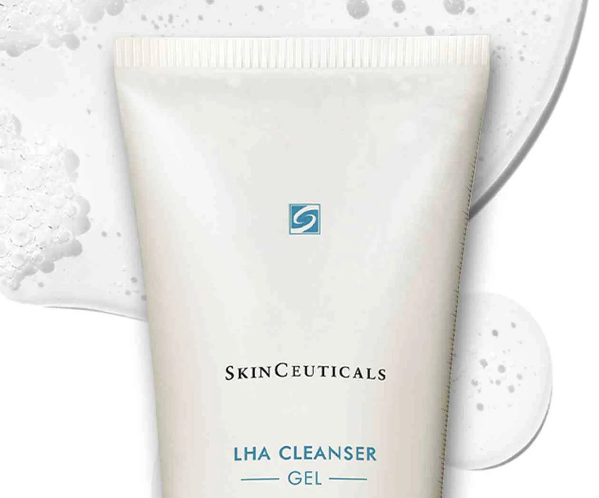 A tube of SkinCeuticals LHA Cleanser Gel on a white surface with water splashes.