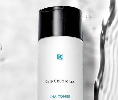 A bottle of SkinCeuticals LHA Toner with a black cap, placed against a neutral background.