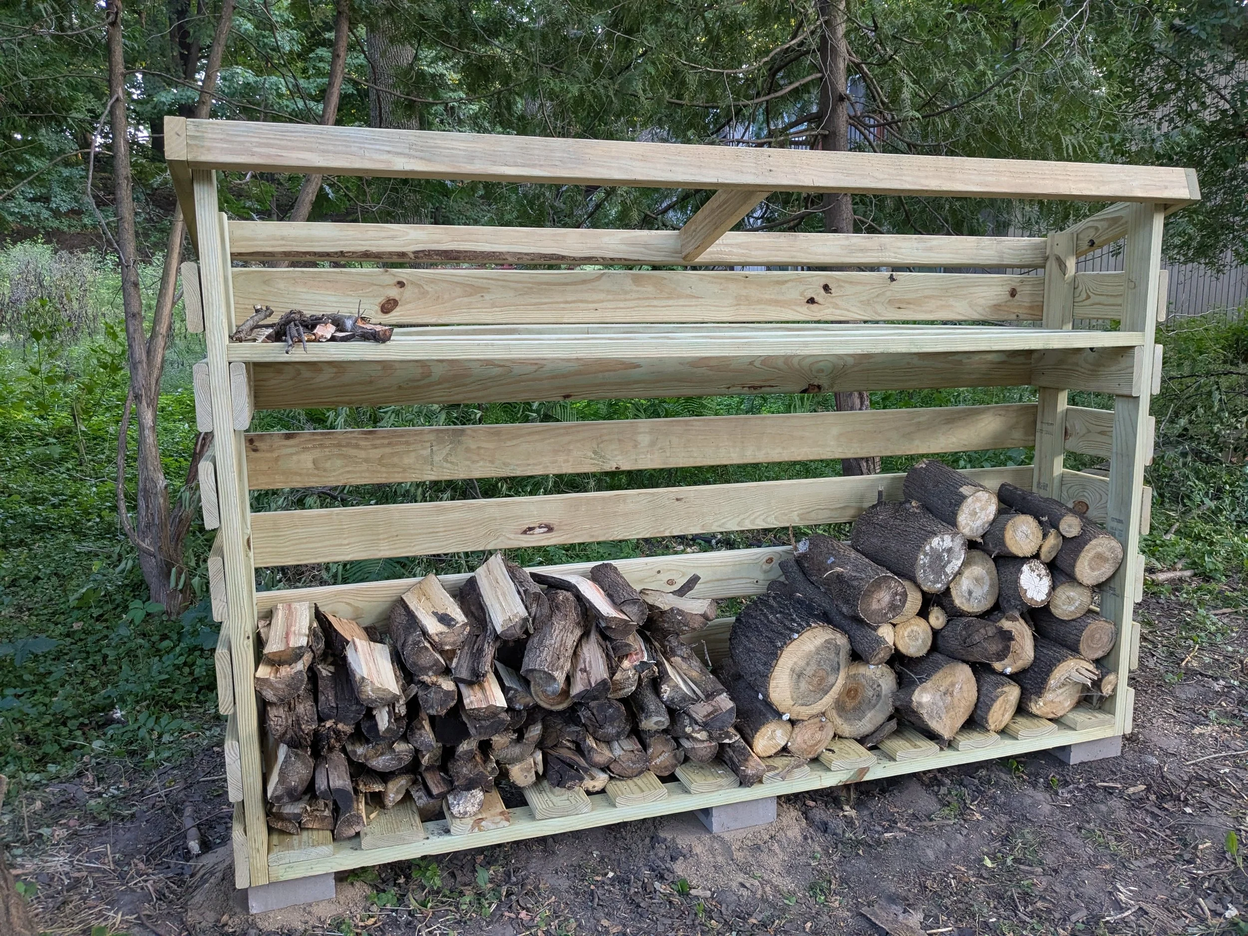 firewood shed partially loaded with wood