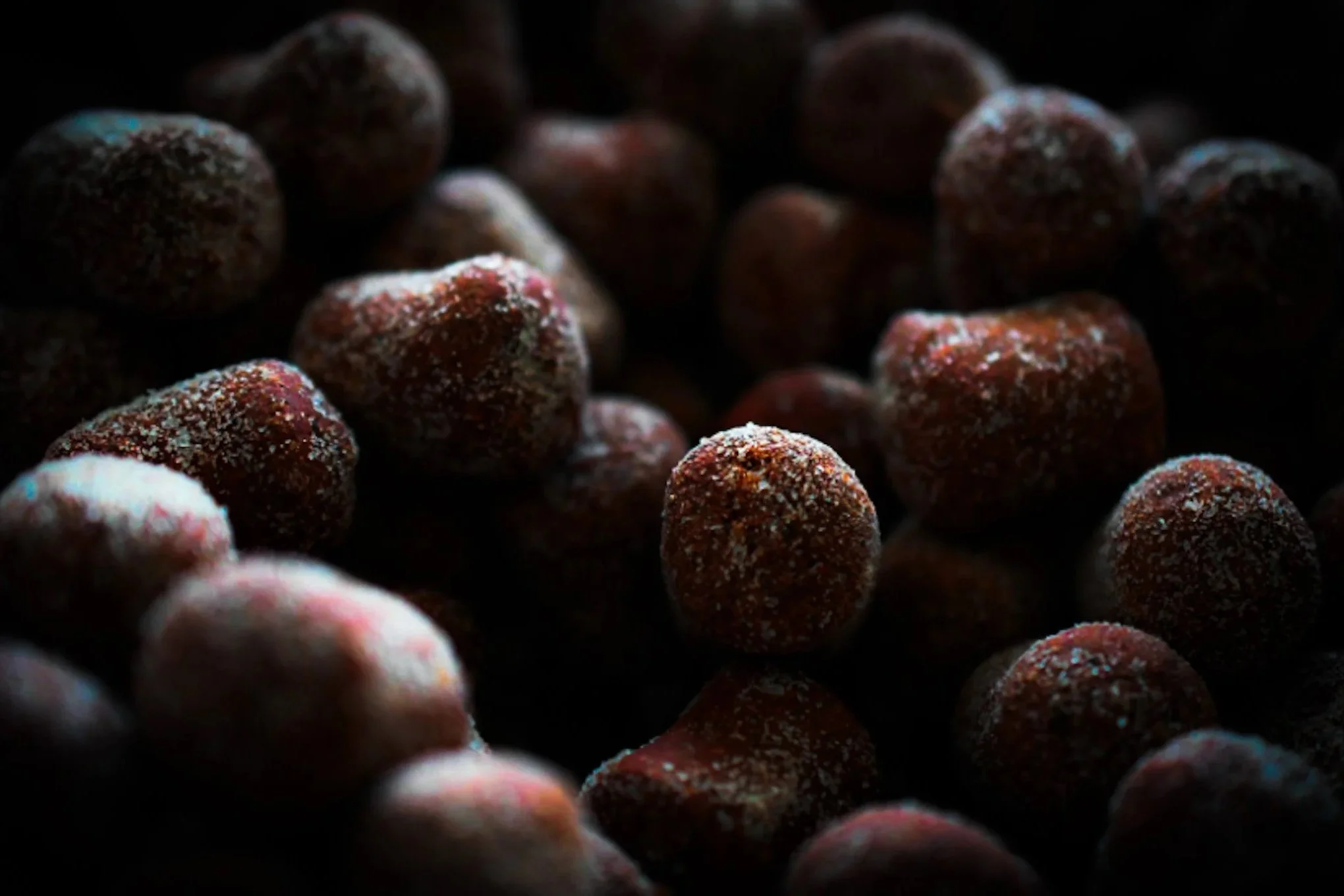 Close-up of freeze-dried strawberries with a dark background.
