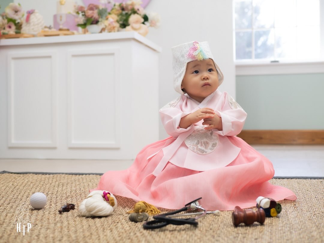 One of the most meaningful parts of the Korean dol celebration is the doljabi ceremony where different objects are placed in front of the child that are meant to represent his/her future or occupation.

Common items include:
* String (long life)
* Mo