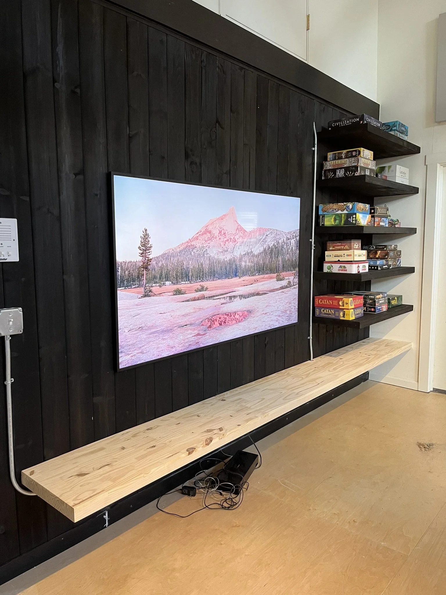 Custom feature wall with floating shelves and wood cladding