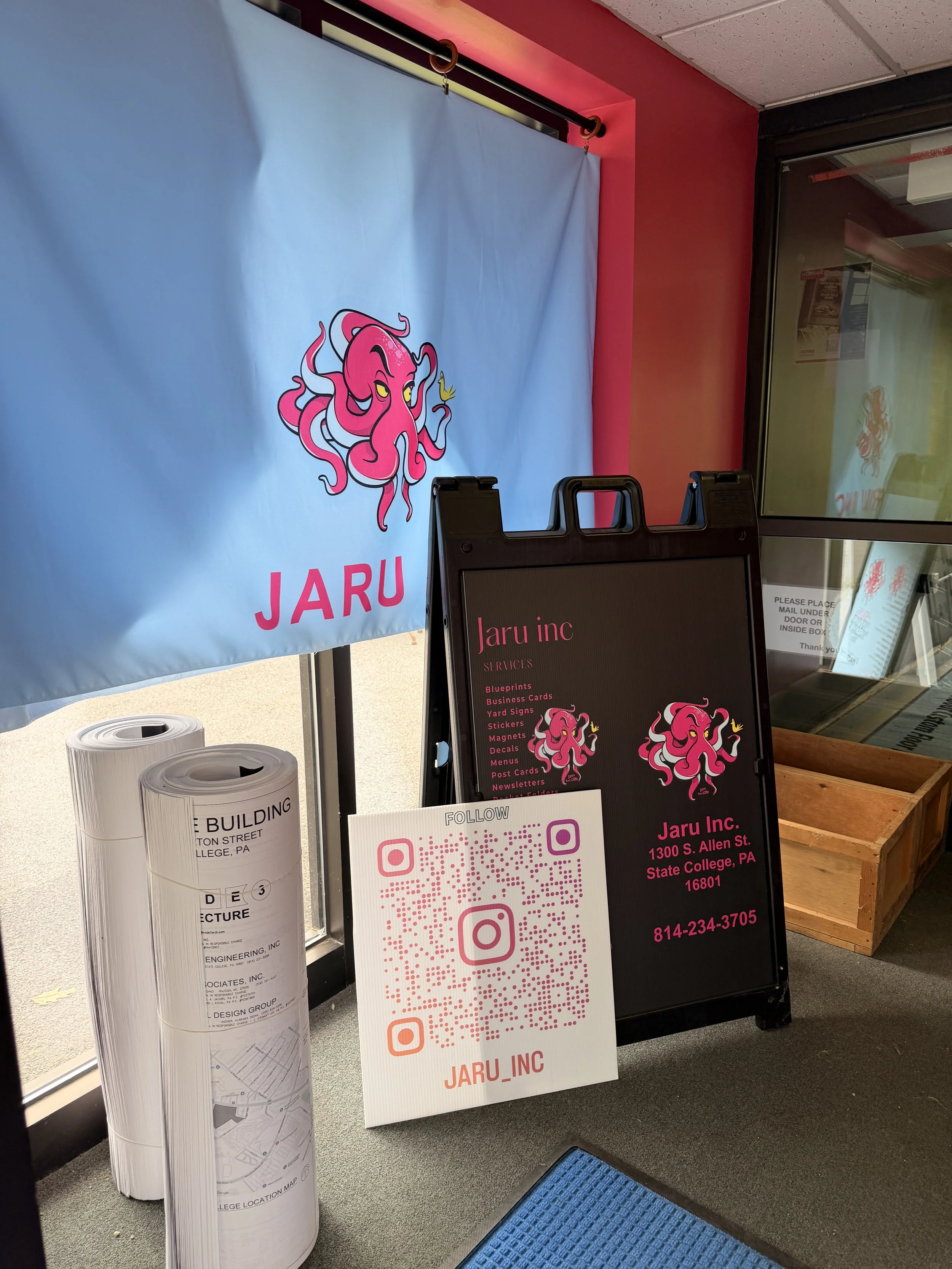 Custom printed banner, sandwich board sign, and branded bags from a State College, PA sign shop