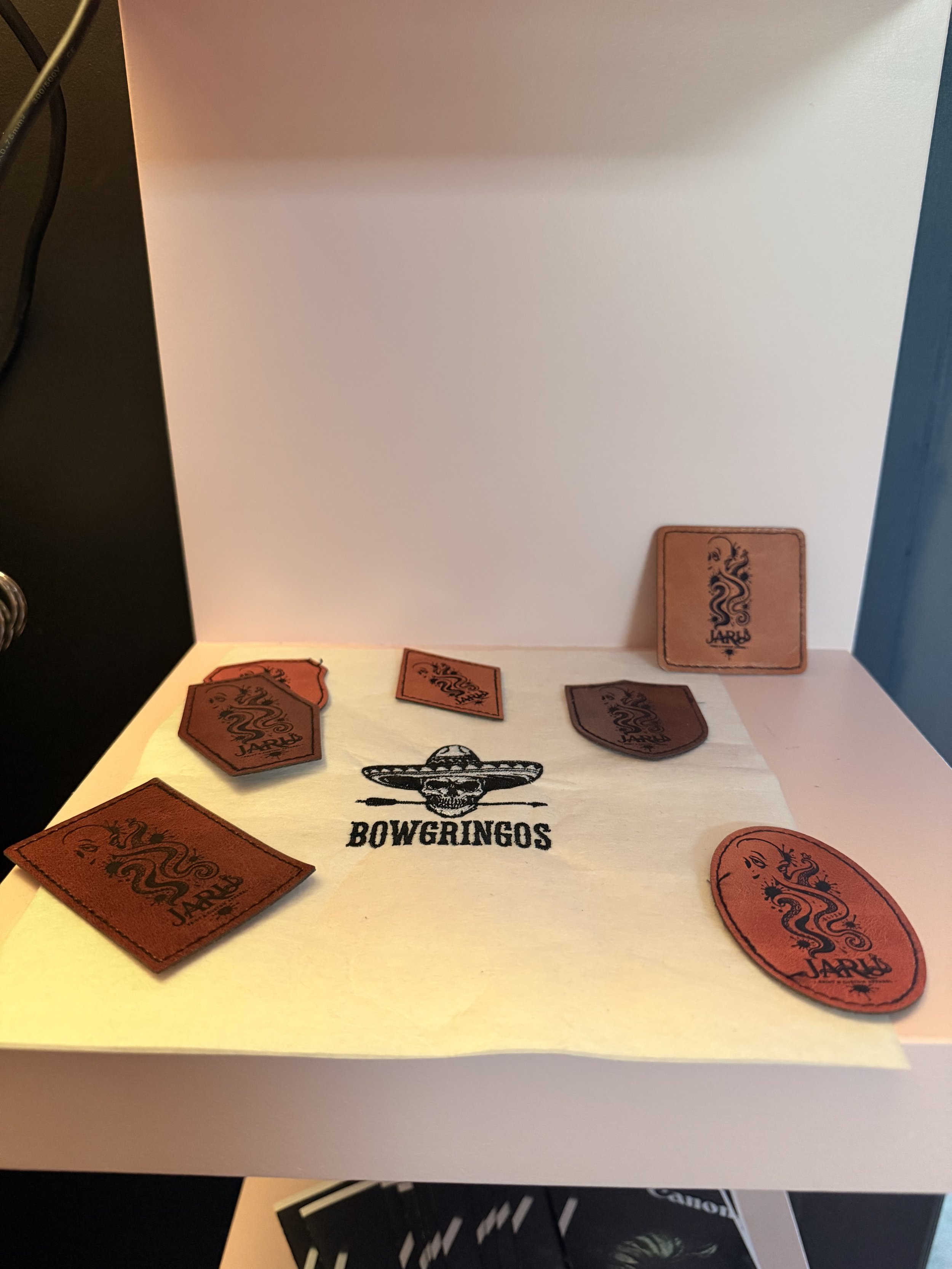 Custom engraved leather patches, coasters, and promotional products from a State College, PA print shop