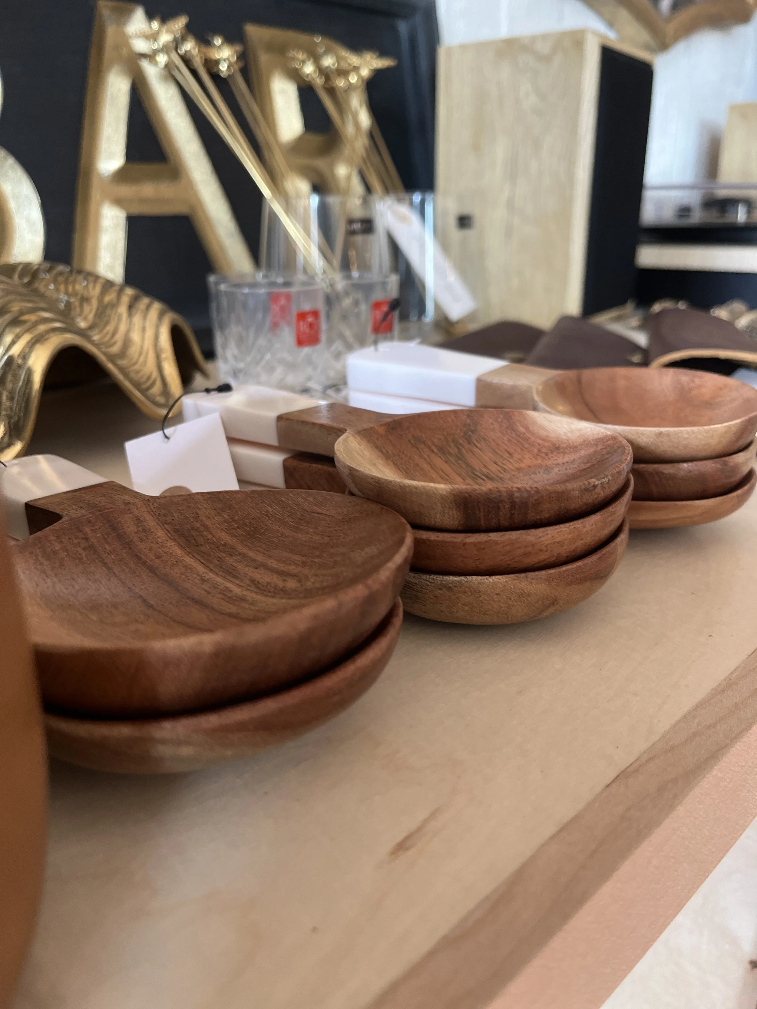 Three different size wooden measuring spoons with white handles displayed at Studio 304