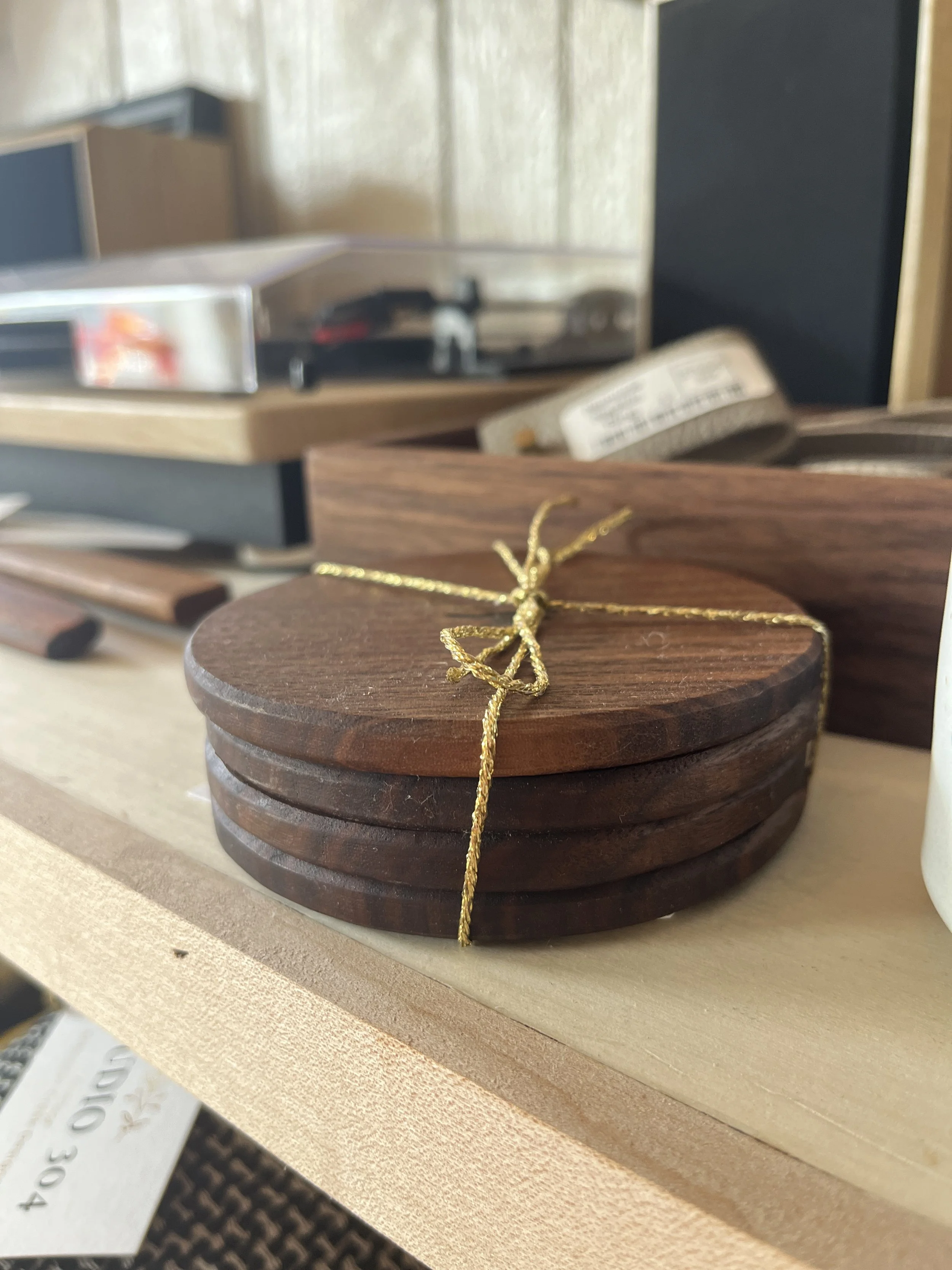 Four hand crafted wooden coasters tied together with twine designed by Schooner Creek Designs