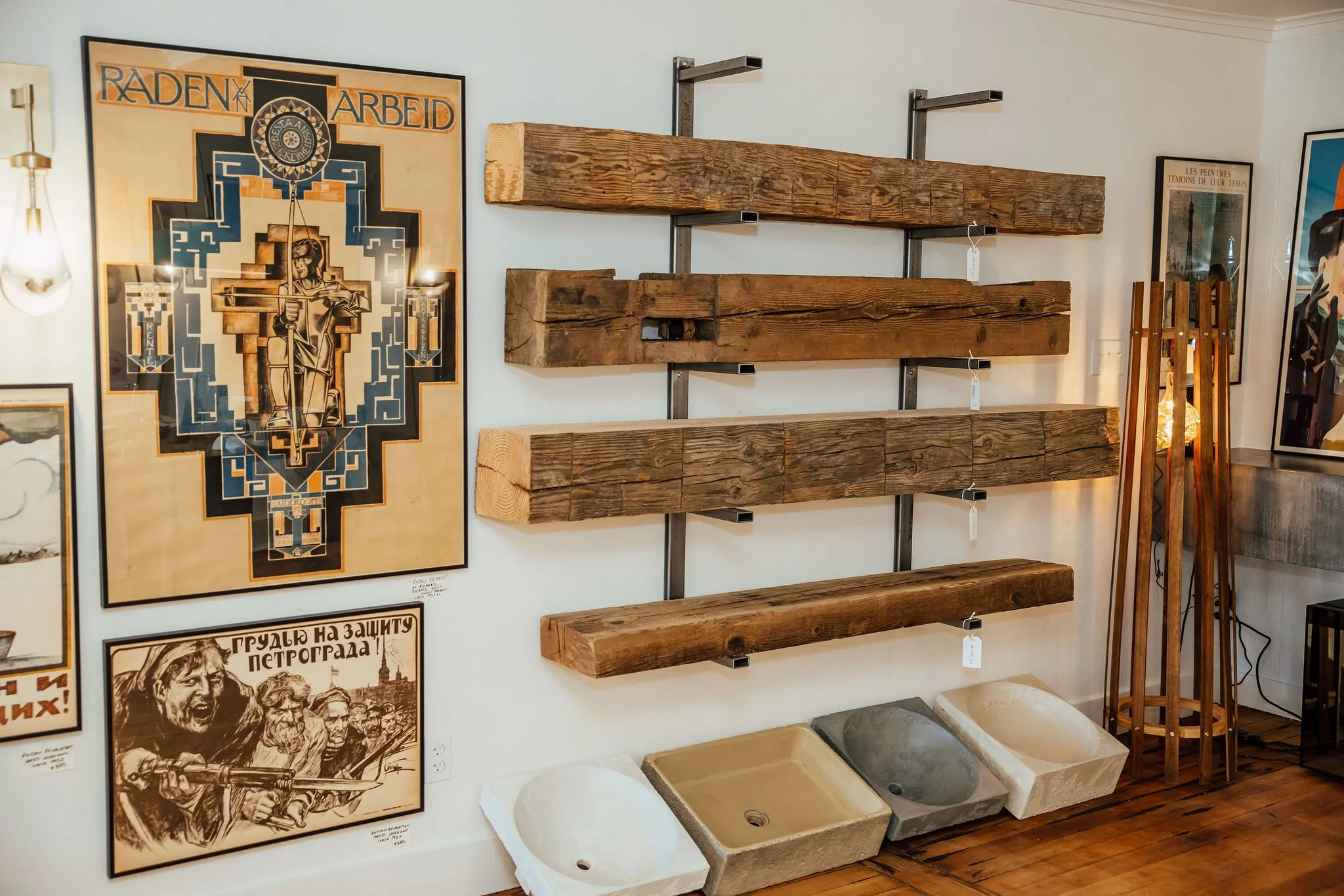 Four custom wood mantels displayed on the wall at Studio 304