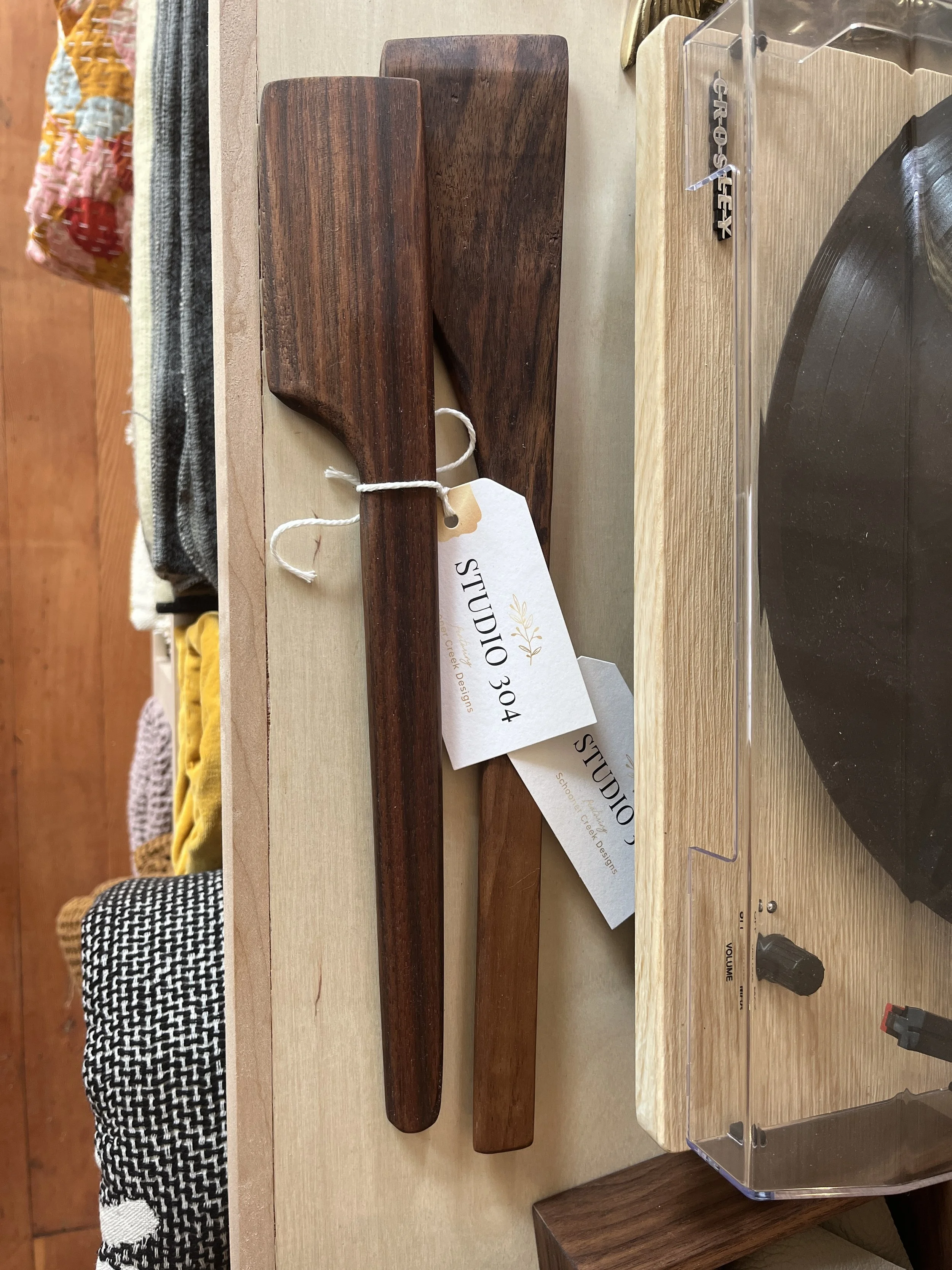 Two wooden Spoons of varying shapes, sizes and colors displayed at Studio 304
