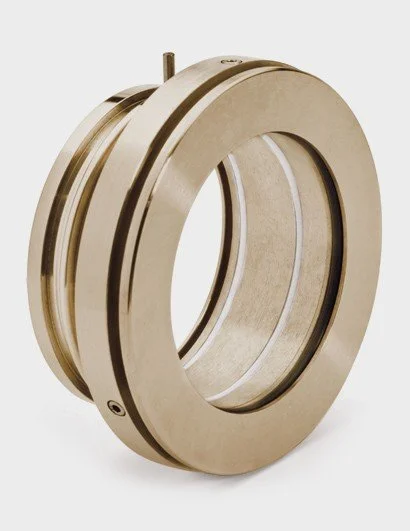 A metallic mechanical component with a circular, ring-like shape and grooves on its surface.