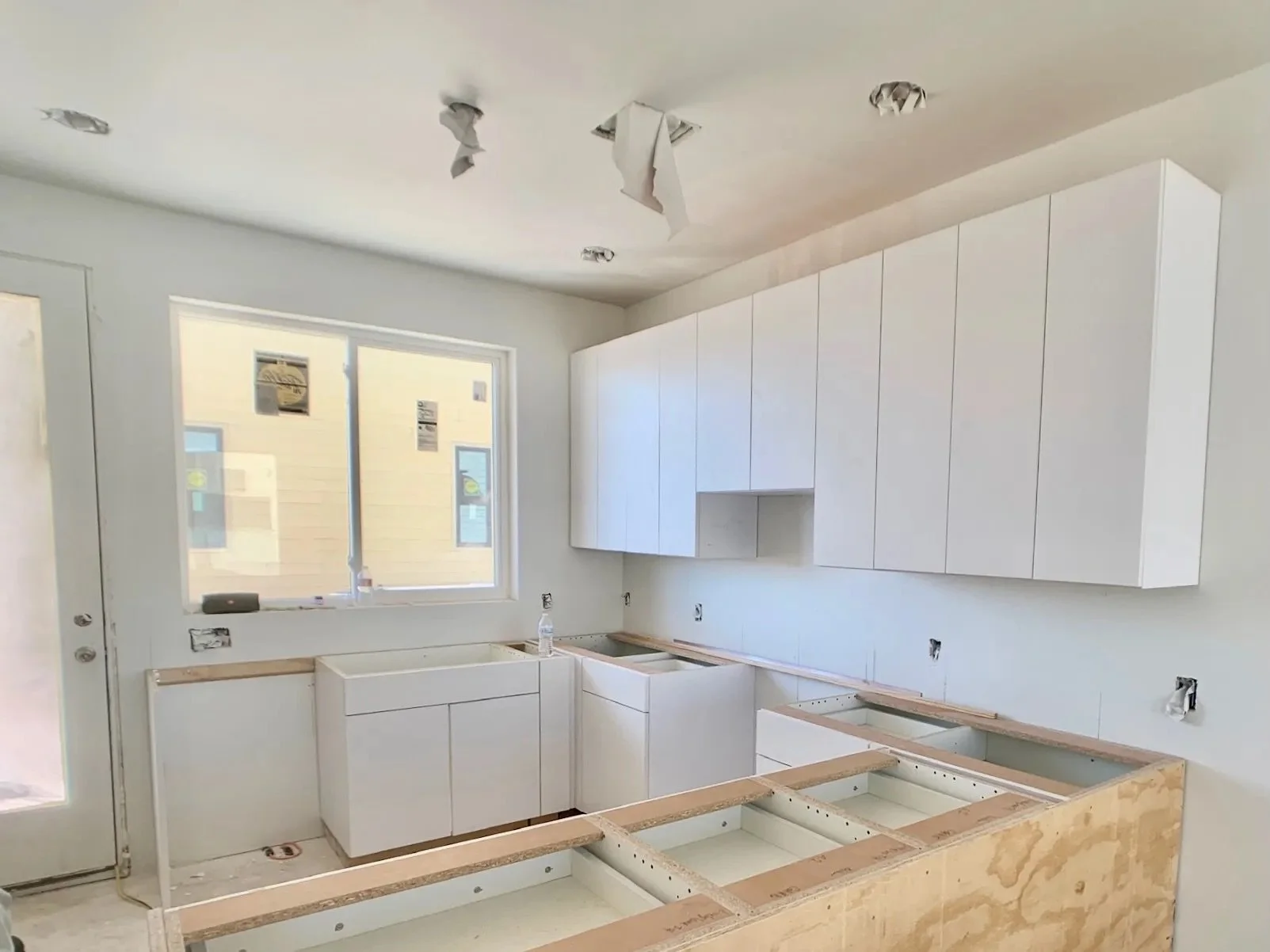  Image of unfinished cabinetry work in a Lively Lane Phase 1 townhome. 
