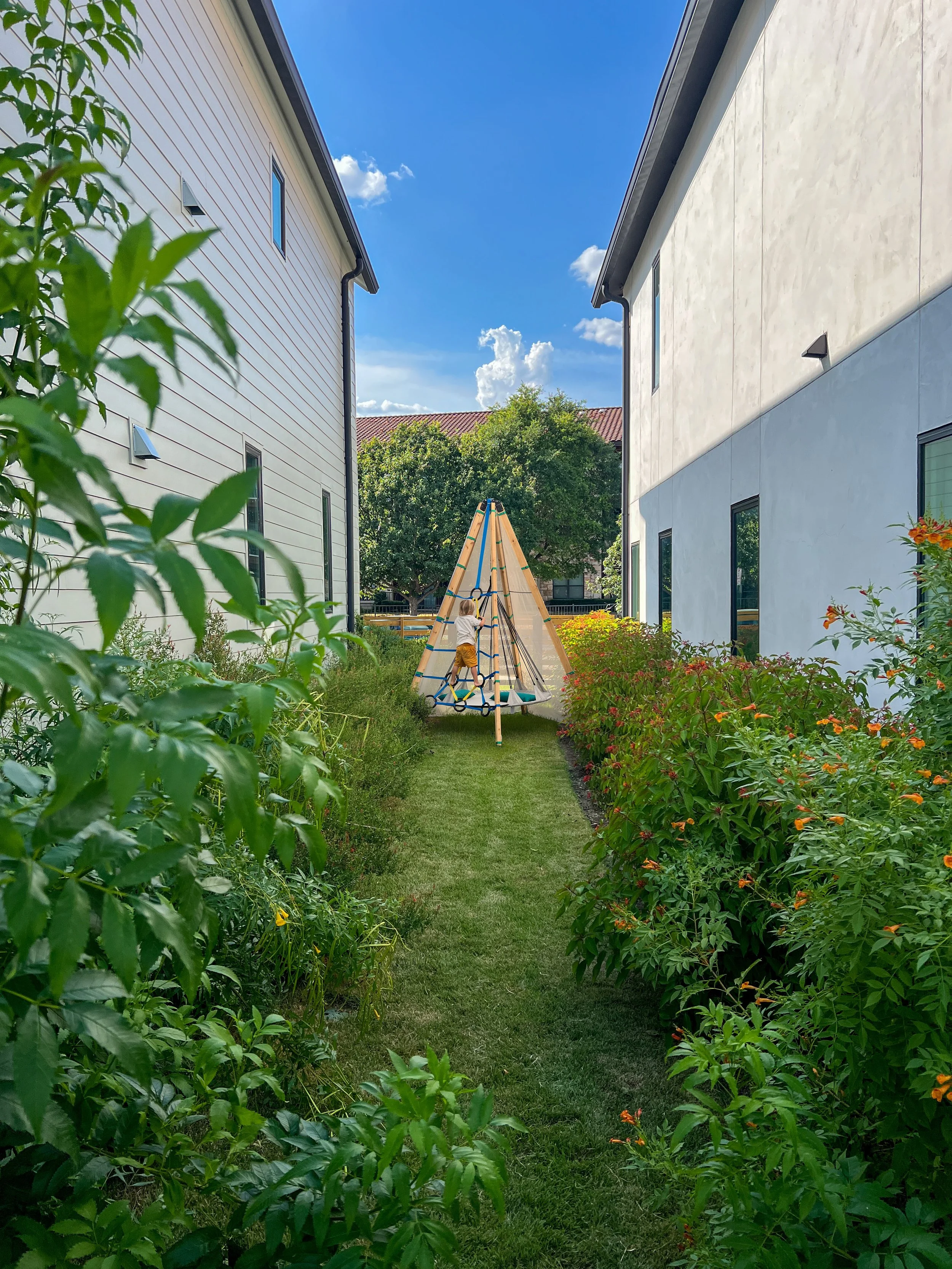 Child free-climbing on a play pod provided at Lively Lane