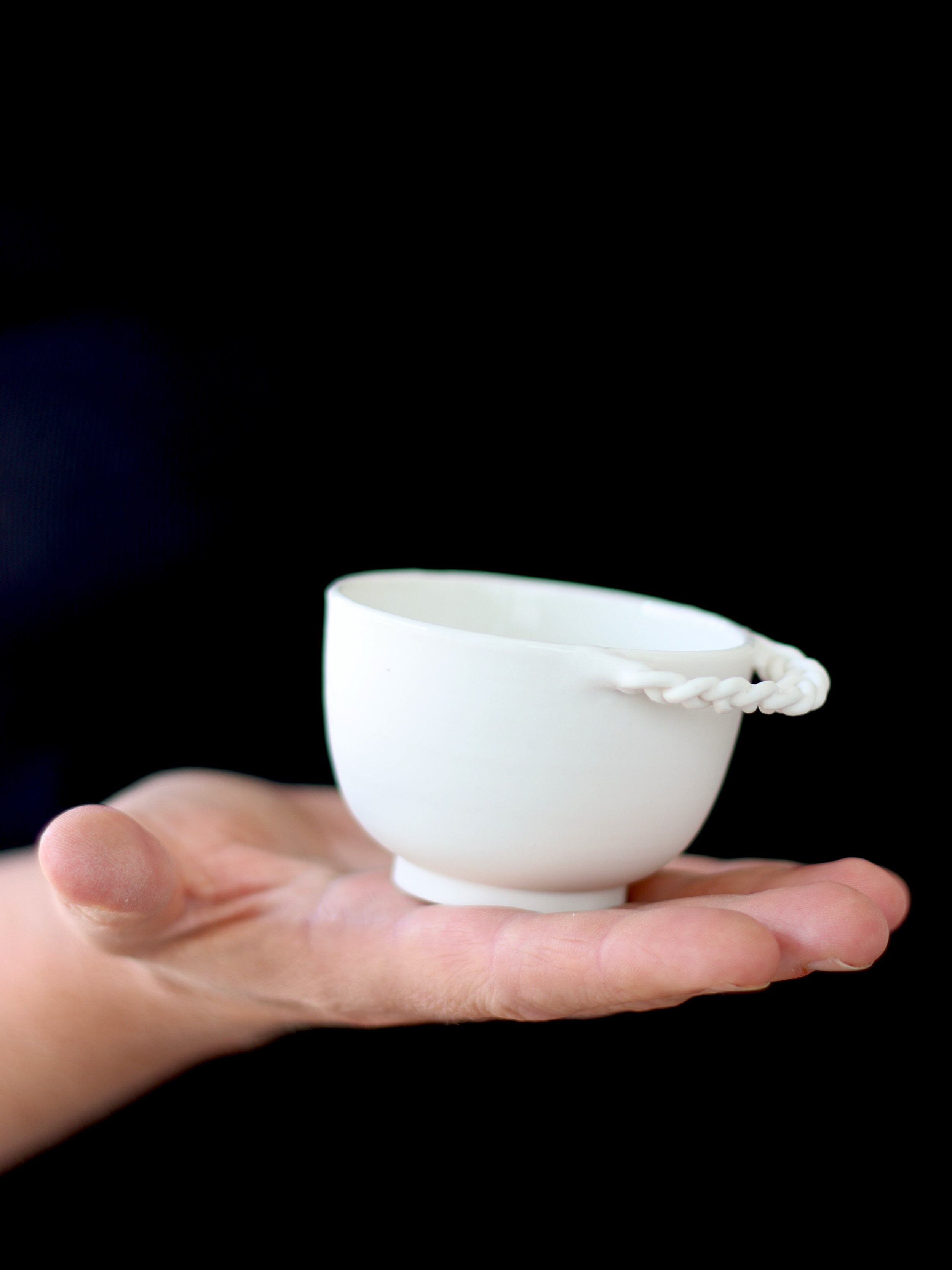A few weeks ago I shared a story about hoops I'd braided out of porcelain, destined to become ears on a series of small cups.

I'll have you know that braiding porcelain and then attaching the braid to a vessel is exactly like fitting a screaming chi