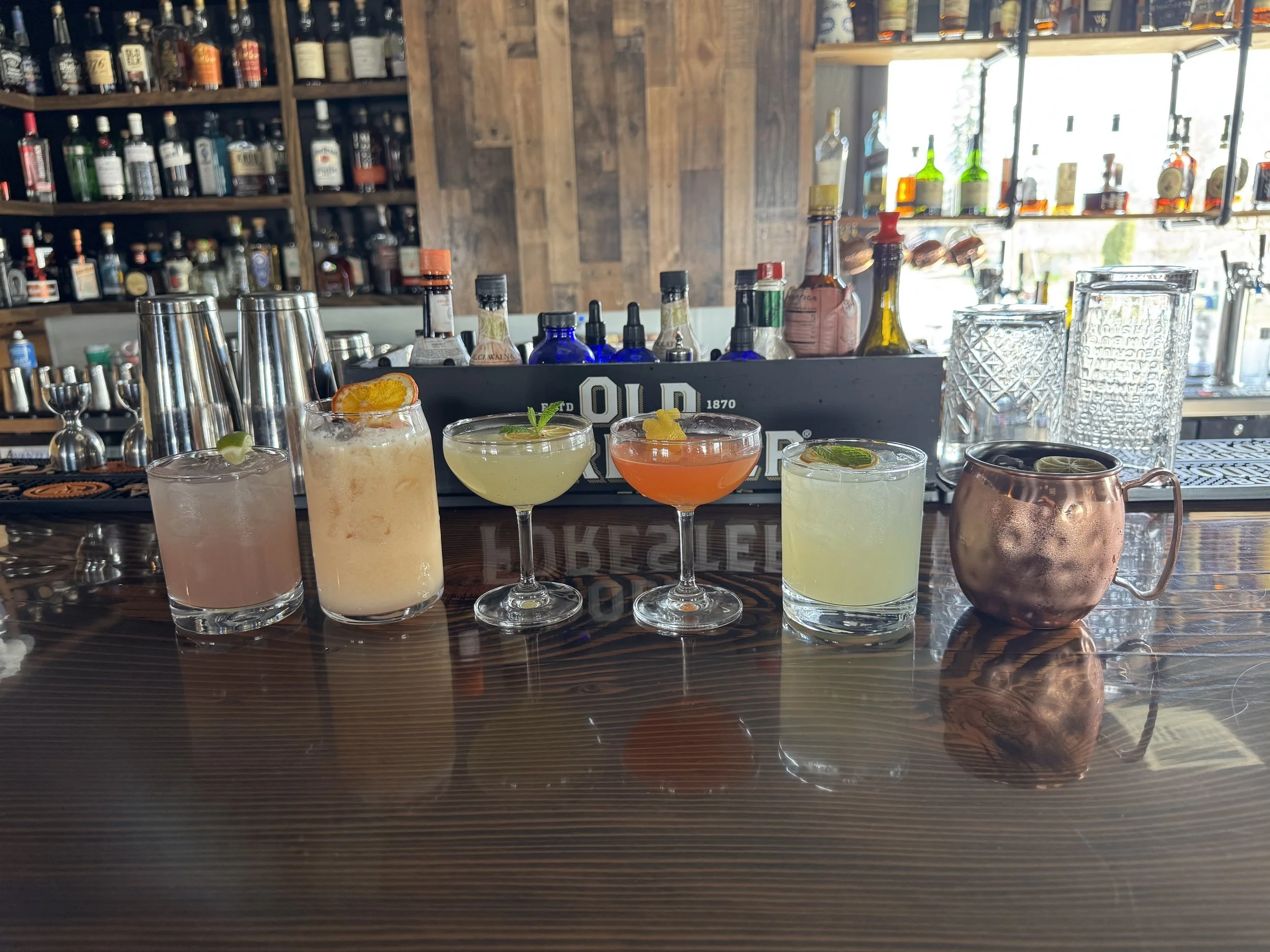 Row of different cocktails on the upstairs whiskey lounge bar.
