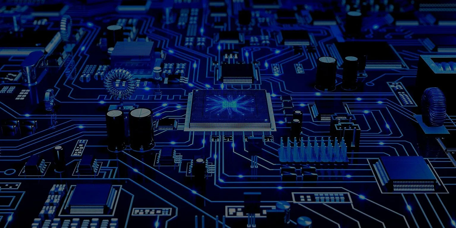 Close-up of a computer motherboard with circuit pathways illuminated in blue, showcasing various electronic components such as capacitors, resistors, and chips.