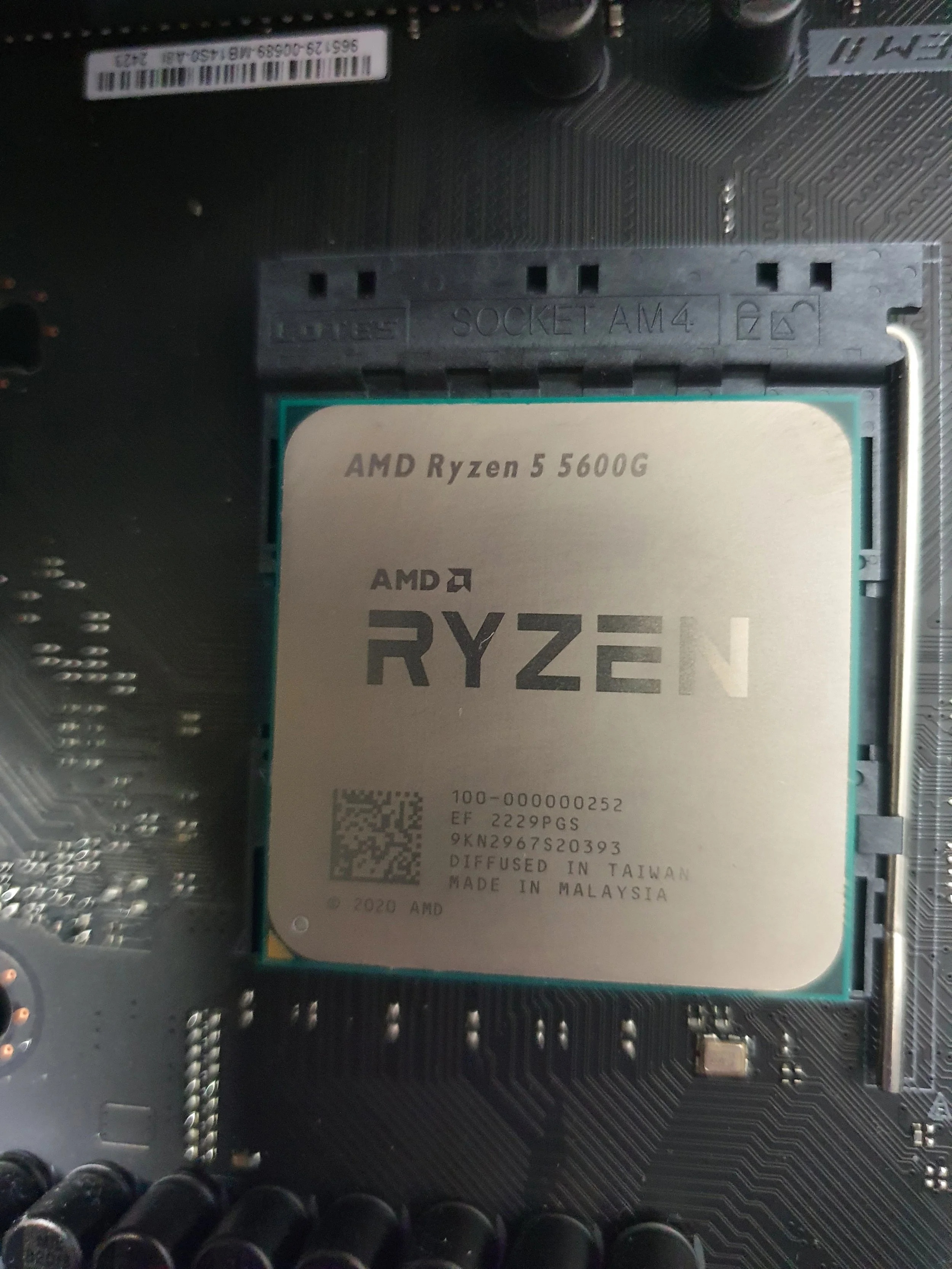 Close-up image of an AMD Ryzen 5 5600G processor installed on a computer motherboard.