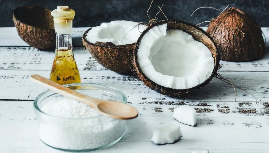 Coconut oil and fresh coconut, highlighting this versatile natural ingredient commonly used in hair and skin care.