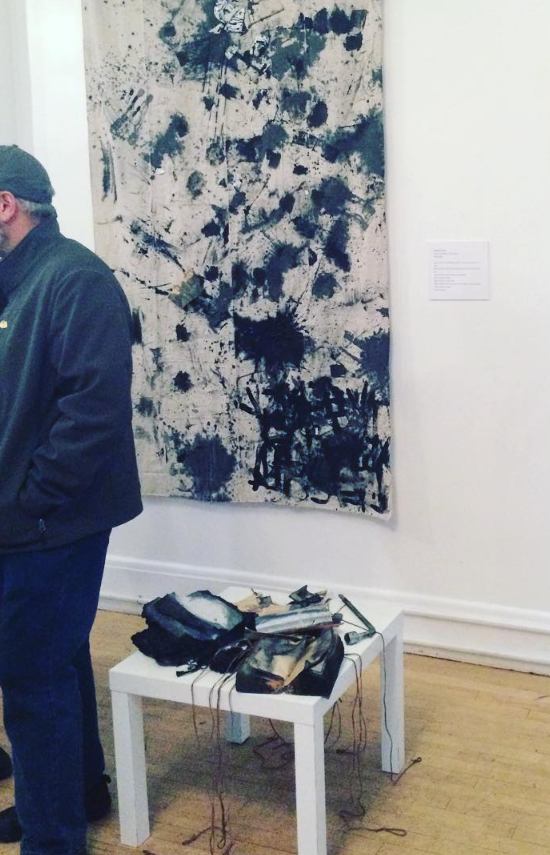 The how to feel better piece by Amanda Rose on display in a gallery.