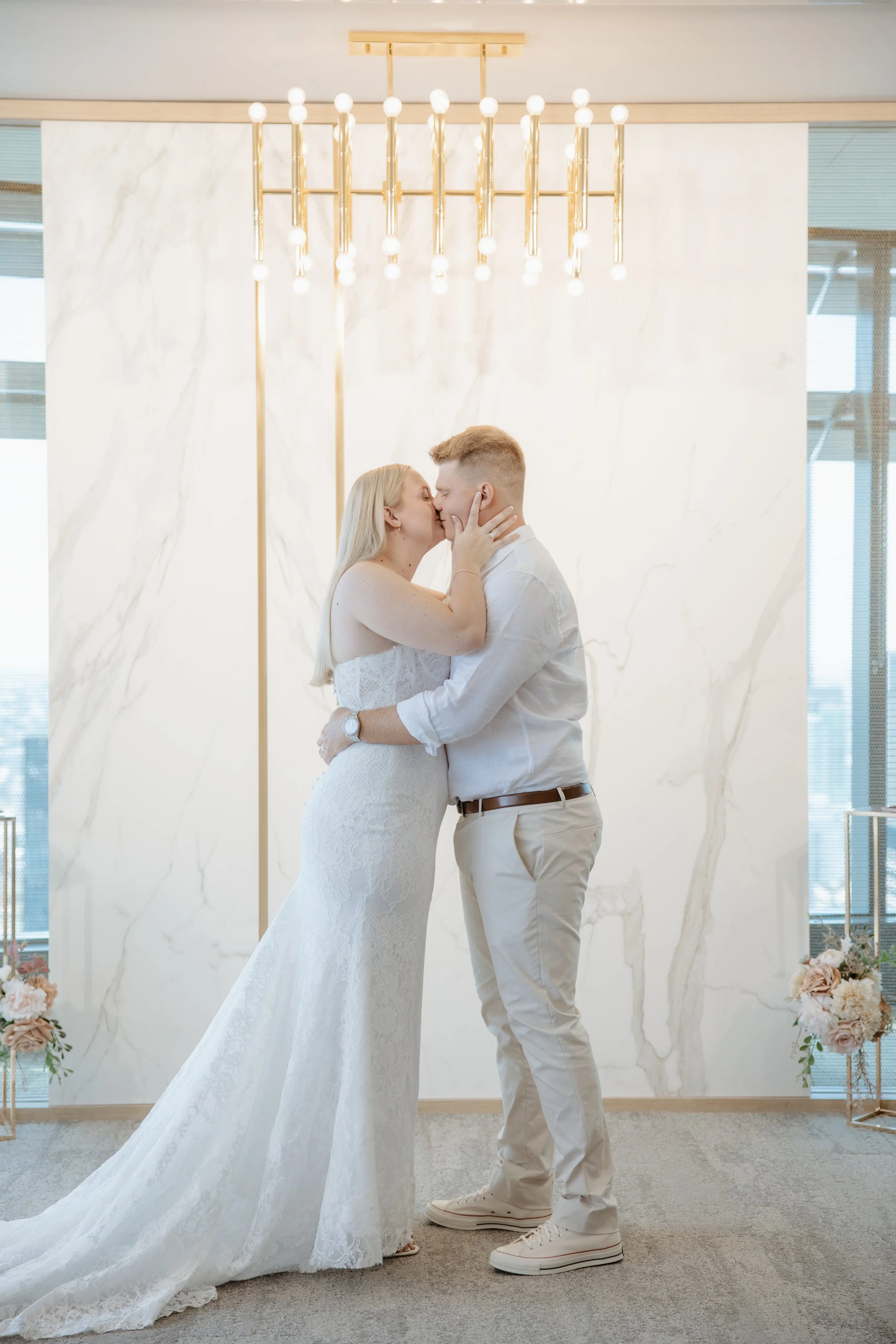 Rachael and Joel sharing a kiss after their wedding ceremony at the Brisbane Registry.