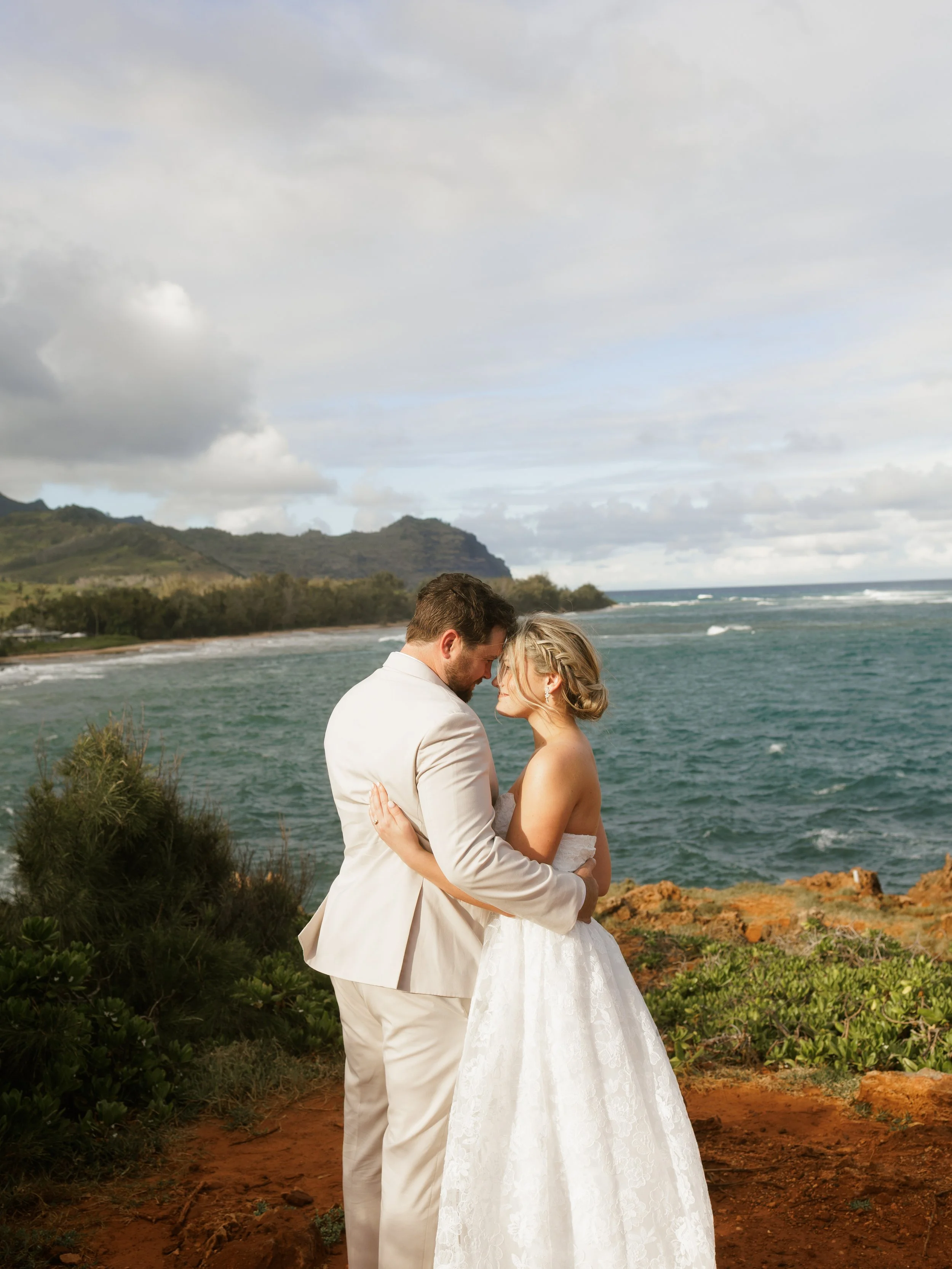  wedding couple touching foreheads on a cliff in kauai