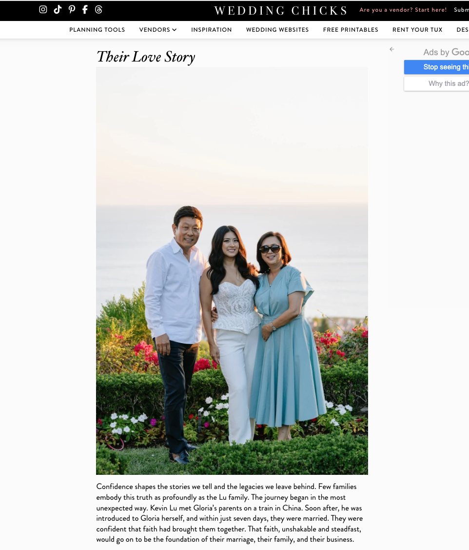 Three people standing together outdoors, a man in a white shirt, a woman in a white top and white pants, and a woman in a light blue dress, overlooking the ocean at sunset. Casablanca Bridal David Suh event JINA KOH calligraphy
