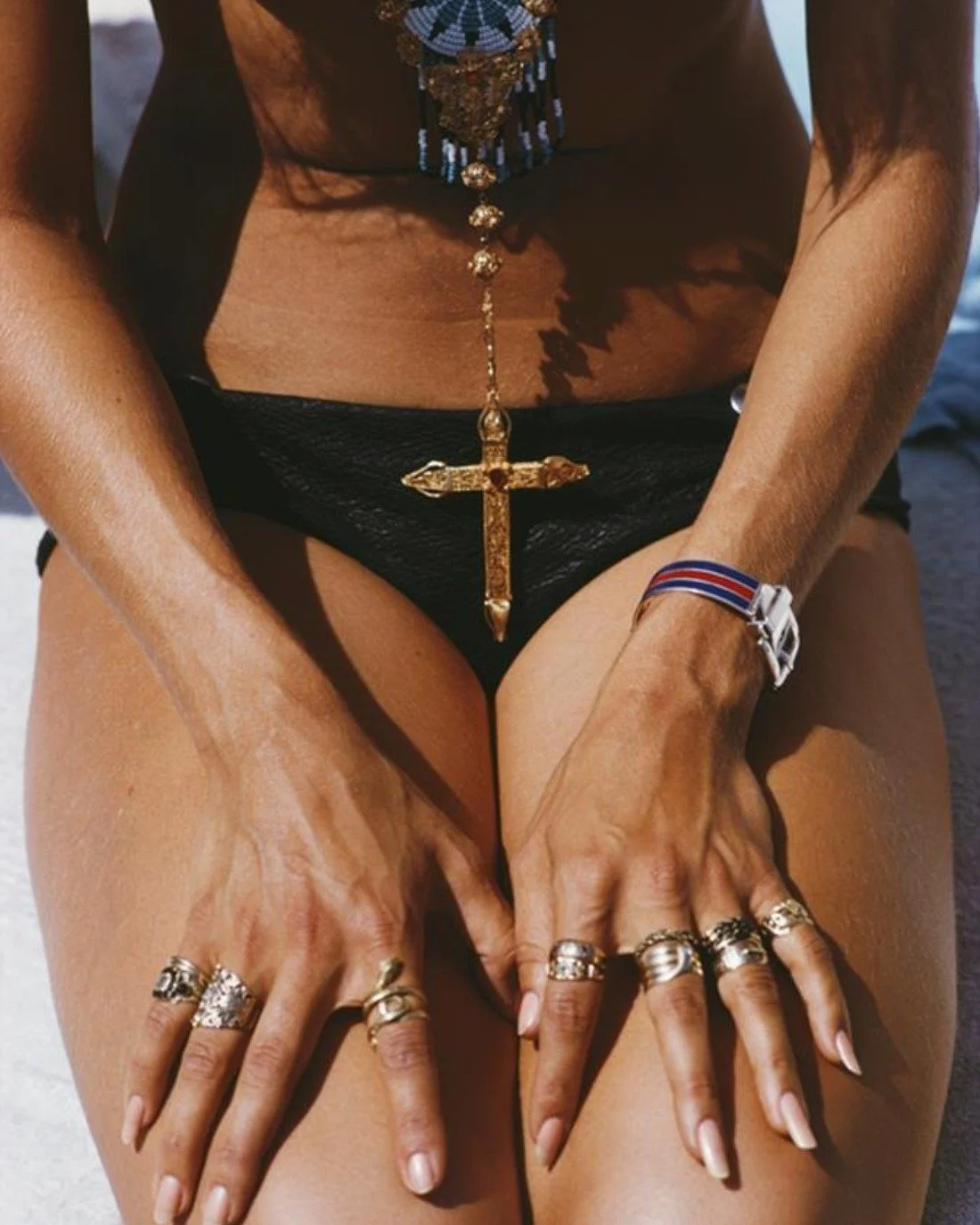 A kneeling sunbather shows off her rings and pendant on a beach in Capri, Italy, 1968.

FINEPRINTCO offers premium quality photographic prints from the Getty Images Gallery, owned and housed by Getty Images. All Slim Aarons prints are hand embossed w