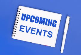 Notebook with 'Upcoming Events' written on the cover, accompanied by a pen, on a blue background.