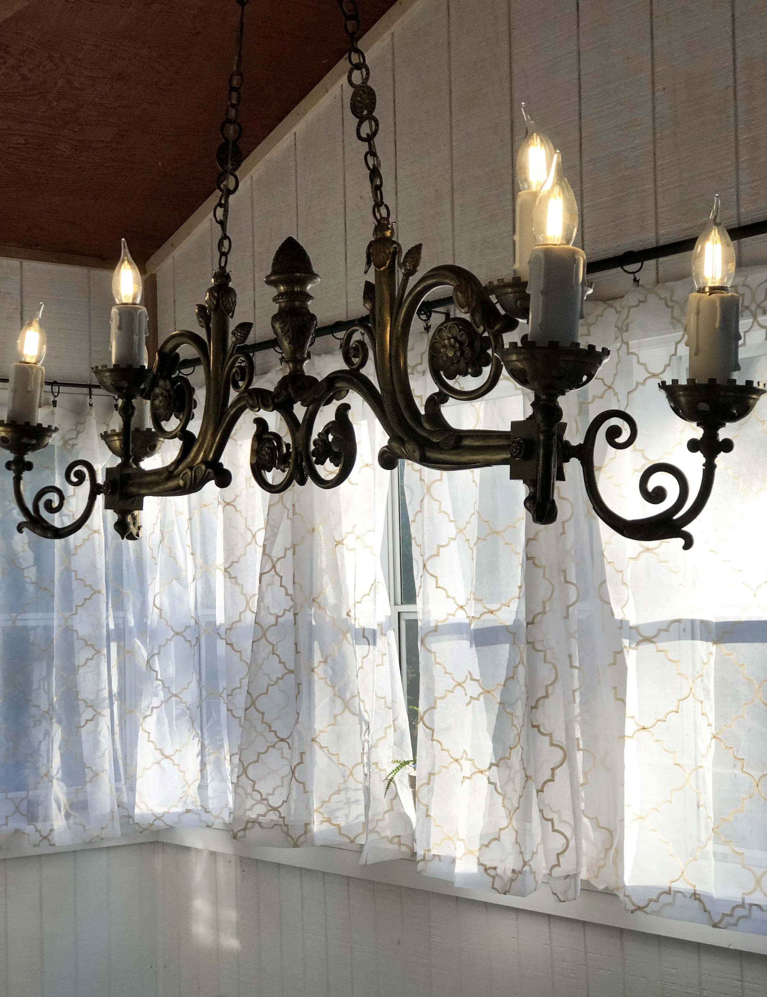 Late afternoon filtered light and a chandelier on a dimmer help transition an outdoor afternoon party into the evening's activities.