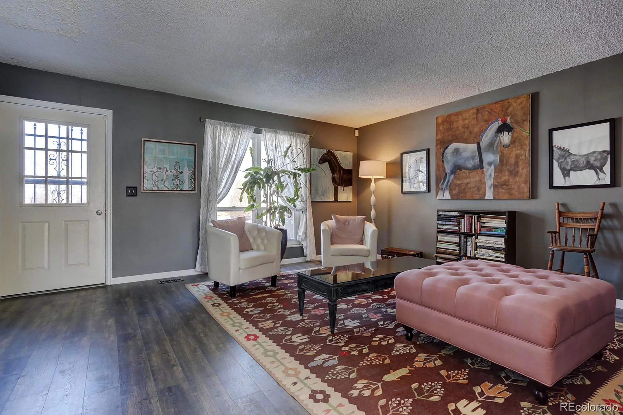 Without the closet obstructing the front door and a portion of the room, the door opens into a spacious formal living room to receive guests.