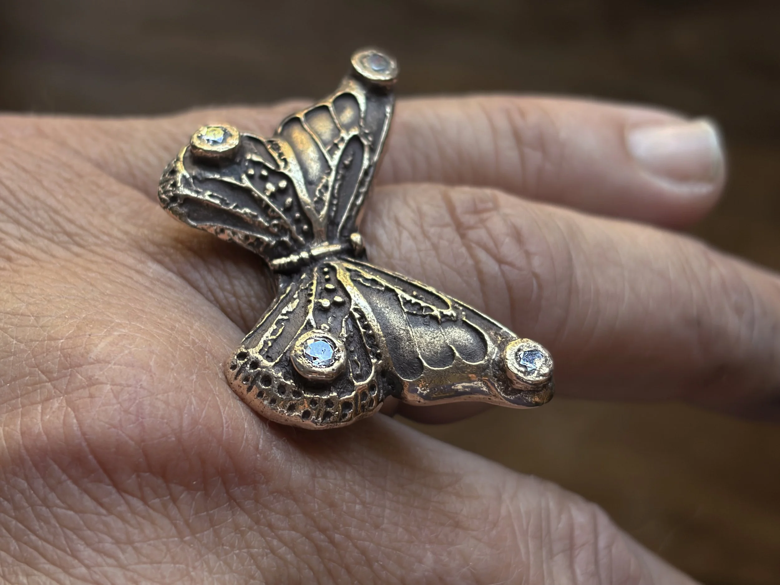 dolly-butterfly-ring-bronze-gemstones-white-small-worn-angled.jpg