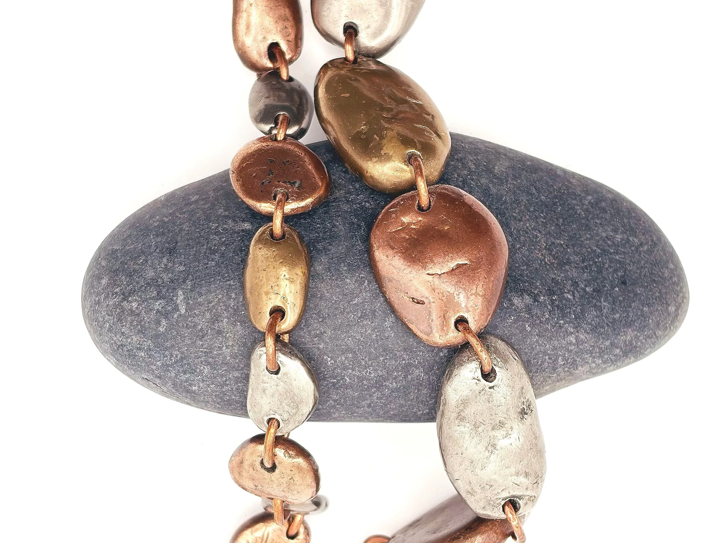 tricolor-river-rock-bracelet-oval-copper-bronze-overhead-birdley-studio.jpg