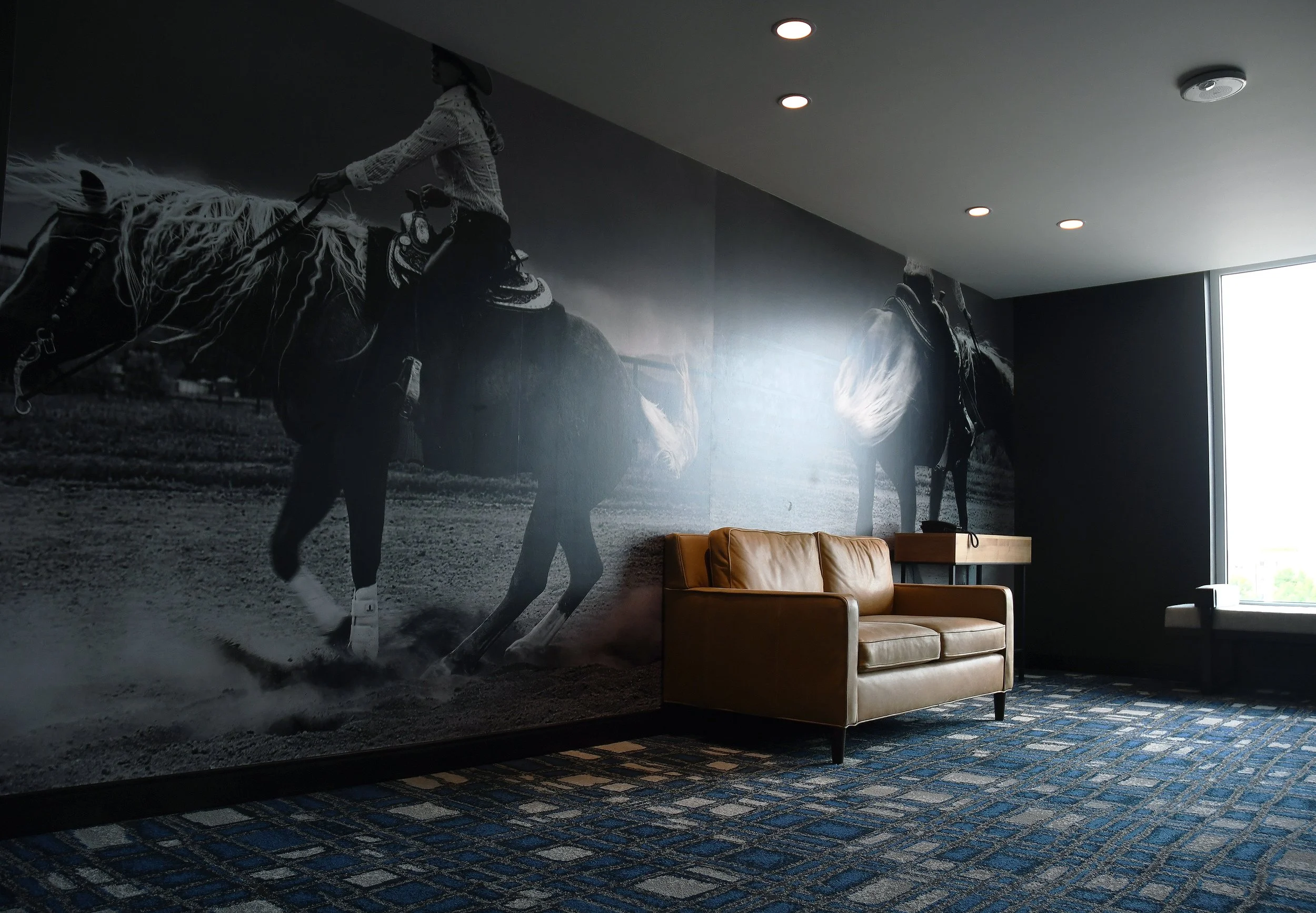 A mural view with sofa and telephone table for scale.