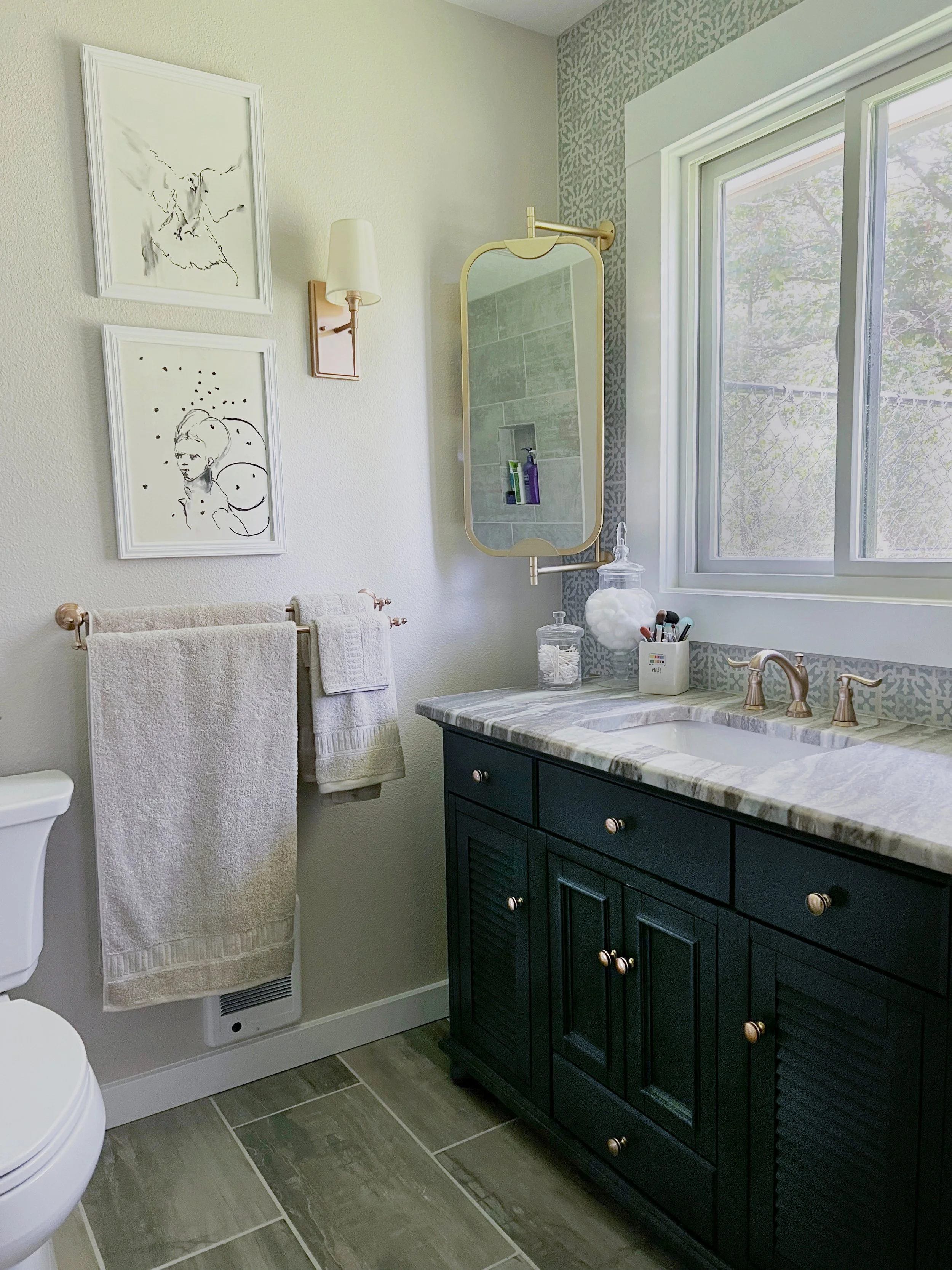 There is just enough of a blue/green squiggle through the granite vanity top to tie it all together with the green cast of the floor and the muted blue/green pattern in the Moorish-style tile. And of course, a blue-green vanity with rich champagne b