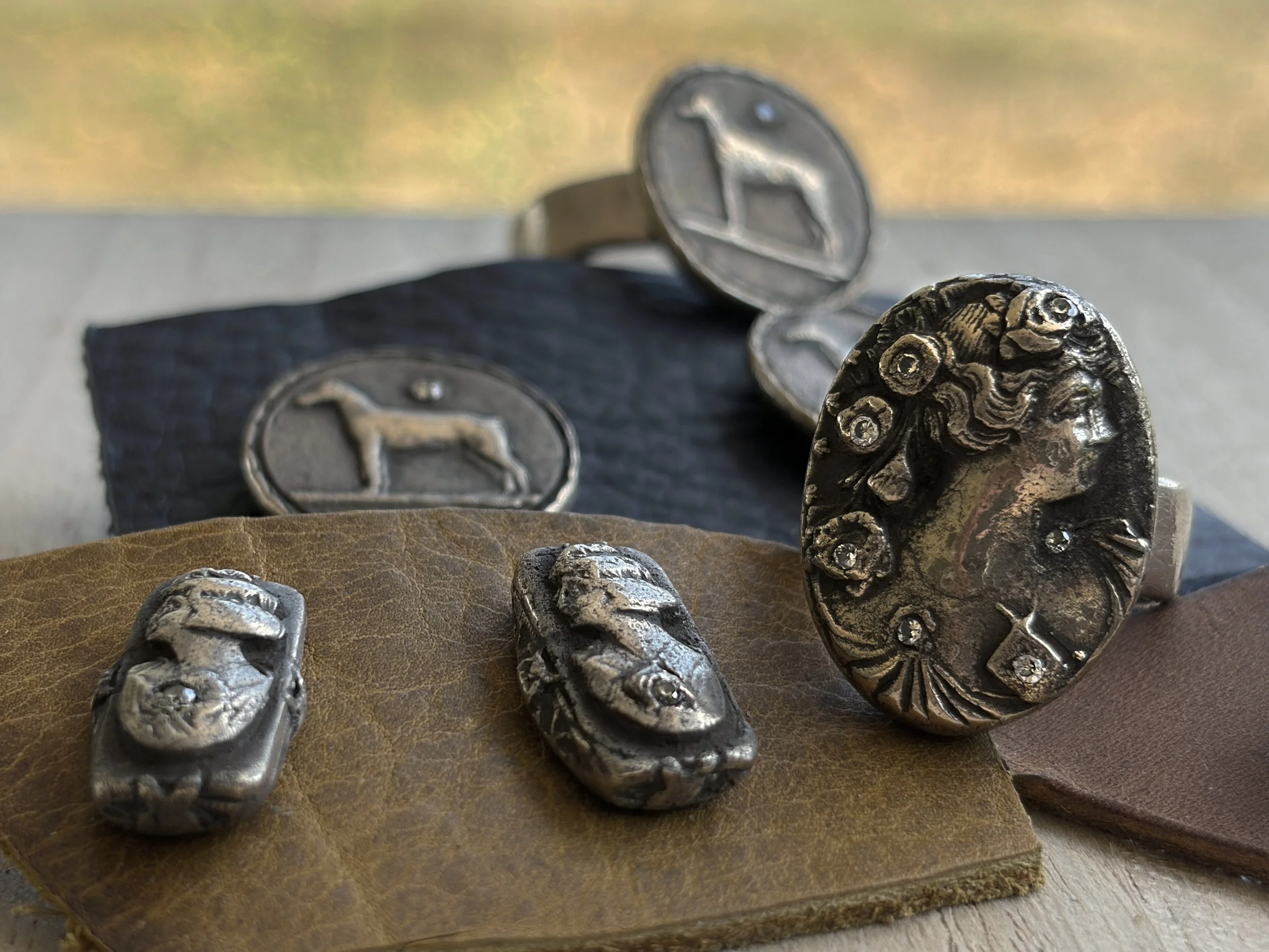 heirloom-collection-rings-stud-earrings-bronze-gemstones-white-display-anglebirdley-studio.jpg
