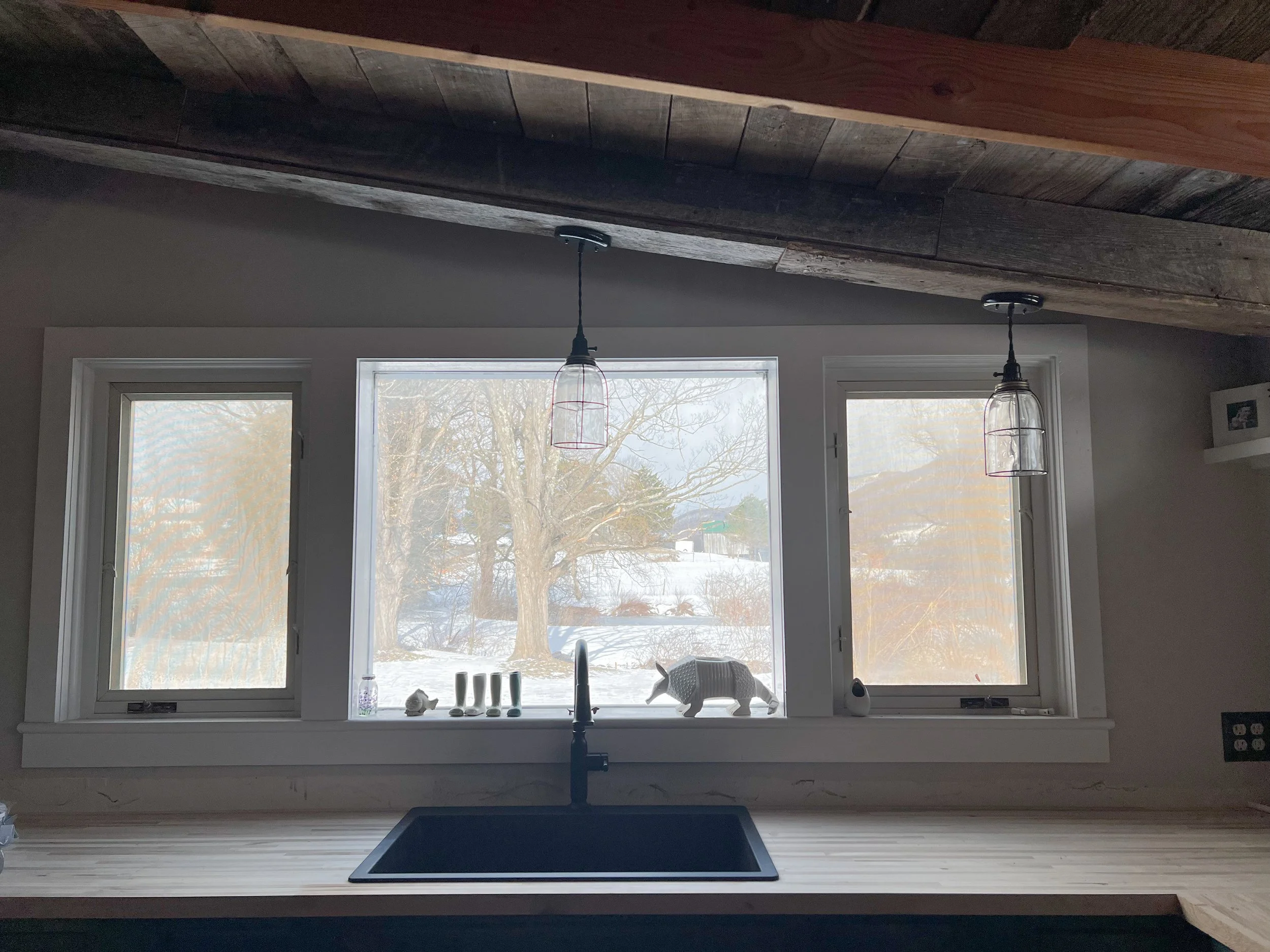 A big black granite/polymer sink certainly does the heavy lifting with a full house. Practically indestructible and aesthetically-striking, it's actually a pleasure to do dishes, especially with a multi-dimensional view: the stream, then the pond, t