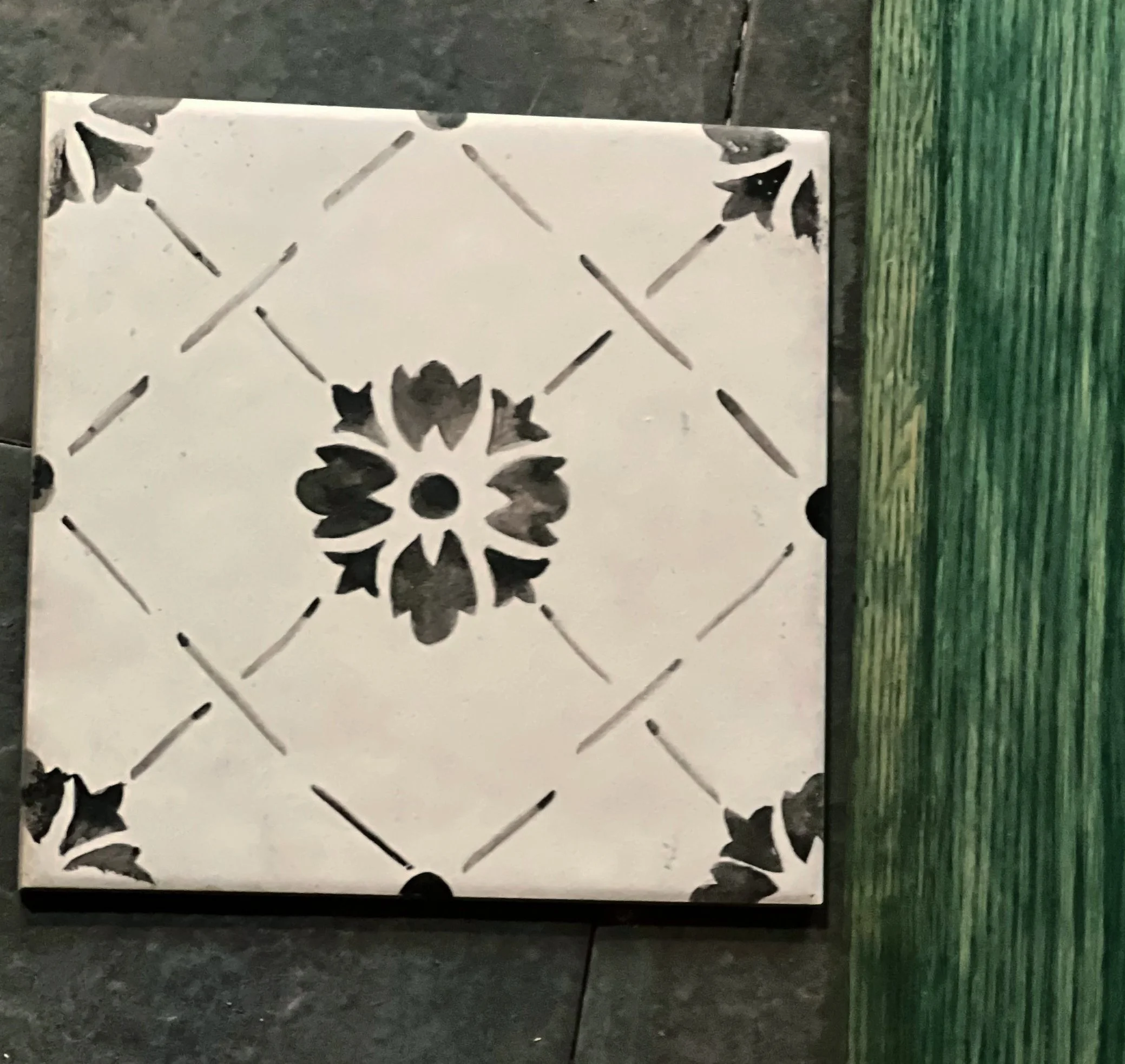 The charming heat source was an outlier, and the best I could do was to bring in a deep color deposit in the same tonal range, beginning with the brick behind it. Green-gray wood stain on solid oak cabinets with gray-tinted butcher block keep thing