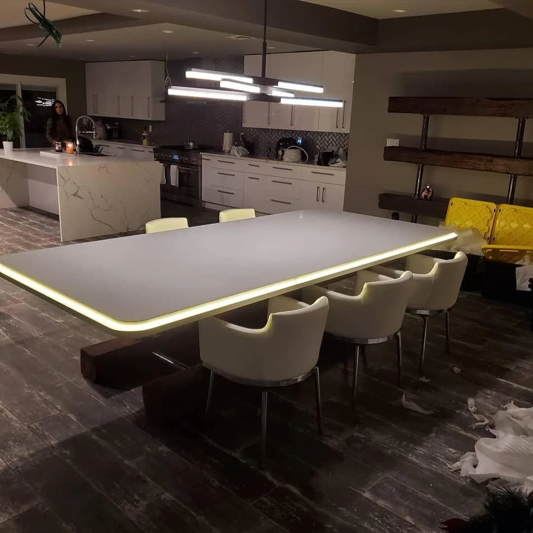 Elegant All-White Kitchen with Waterfall Island and Custom Table