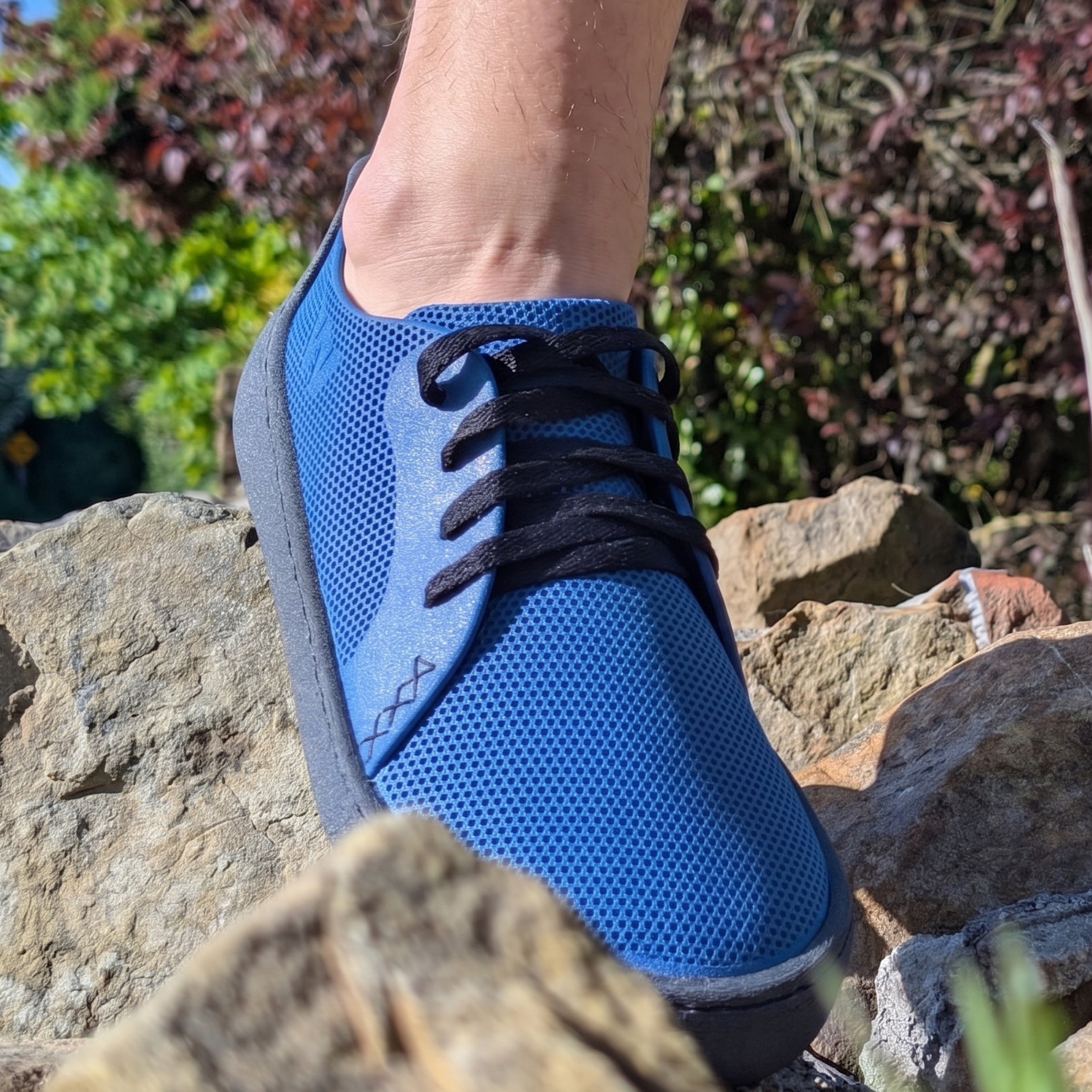 A person wearing a blue METIS shoe outdoors. Top on-demand sustainable shoe models to sell in shops and boutiques with zero wholesale risk.