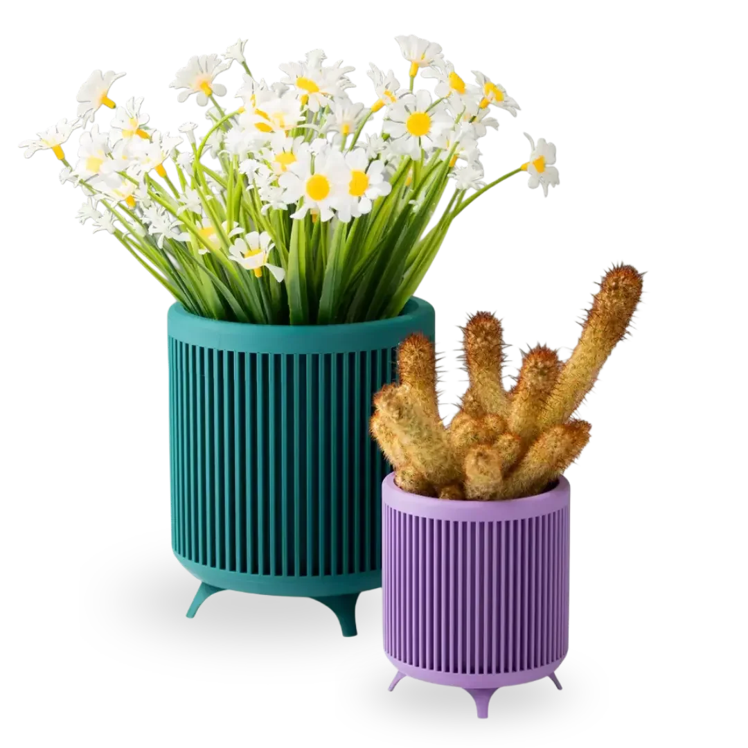 Teal and purple 3D printed planters with flowers, showing WAZP’s catalogue of ready-to-sell homeware products