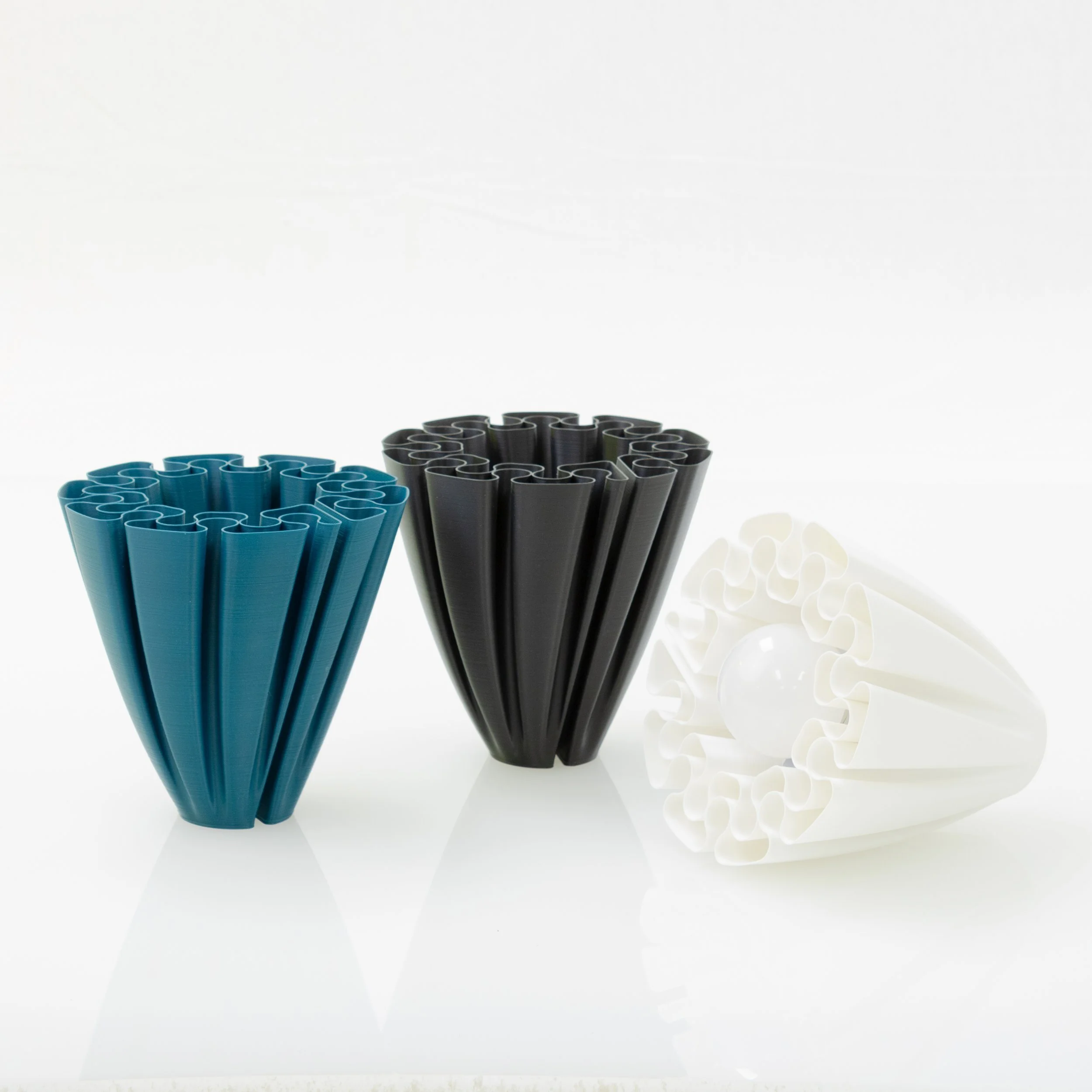 Sustainable 3D printed lamps from WAZP in white, black and blue