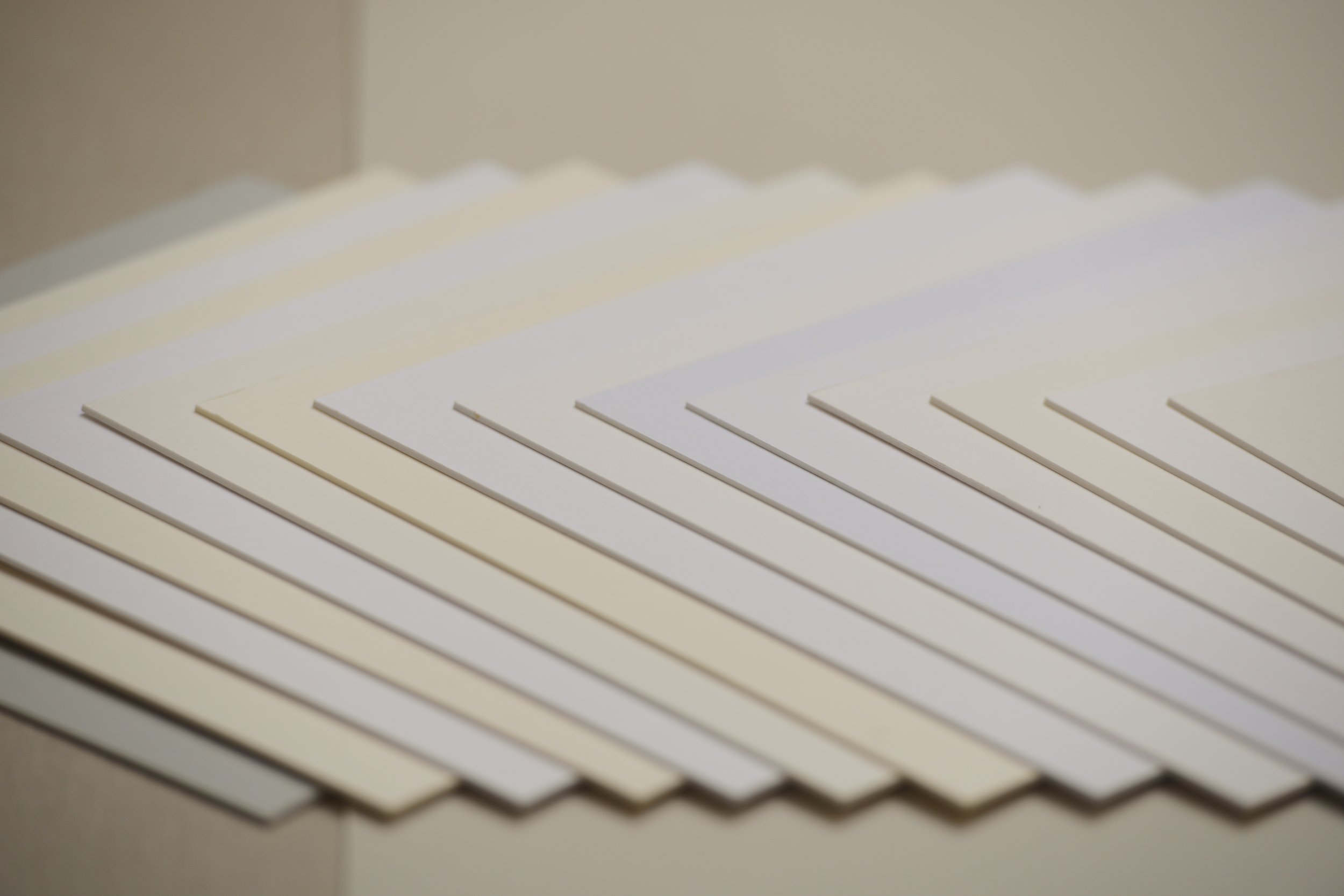 A stack of white paper sheets fanned out on a flat surface.