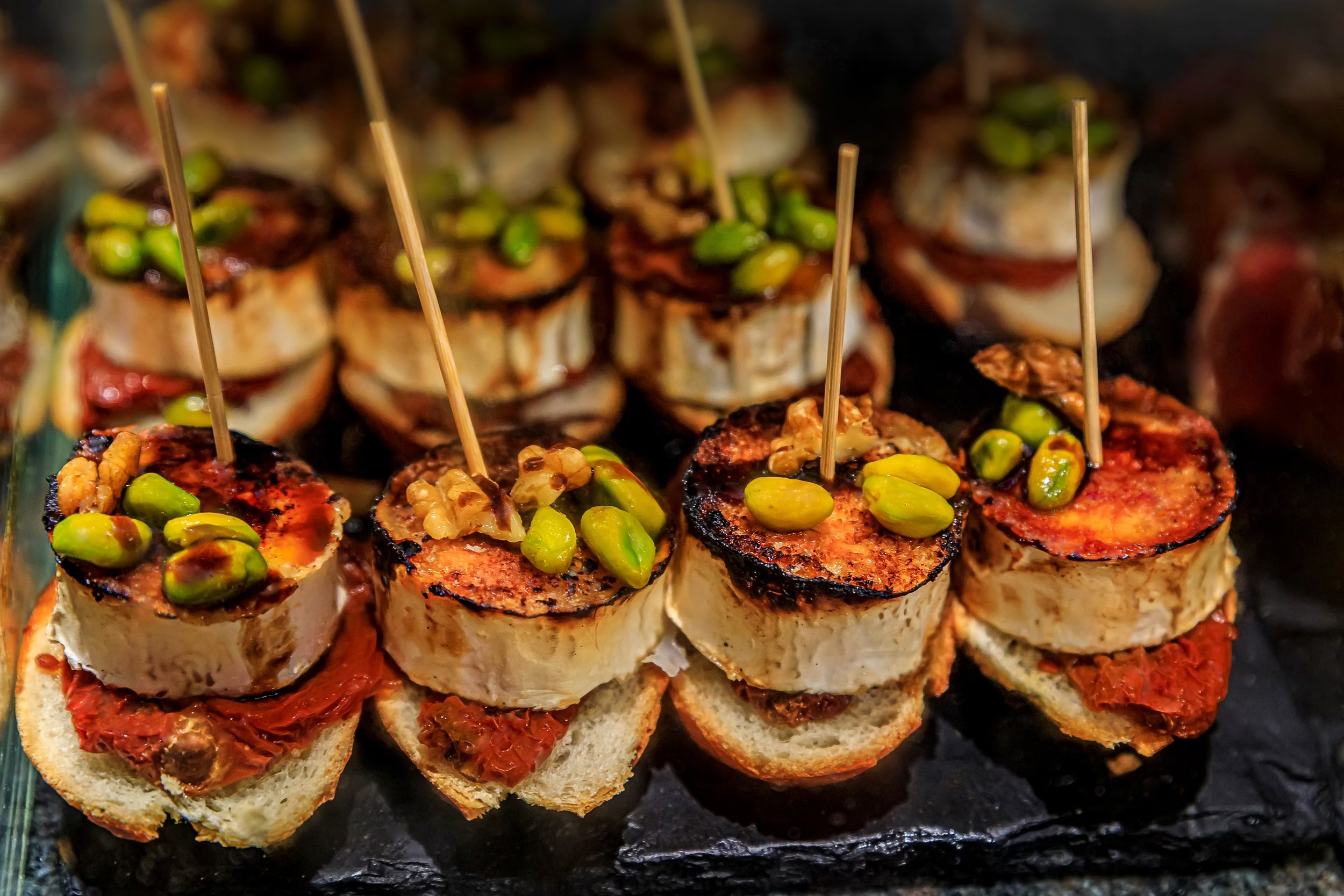 Pintxos with goat cheese, nuts, and red pepper served at a bar in San Sebastián, Spain.
