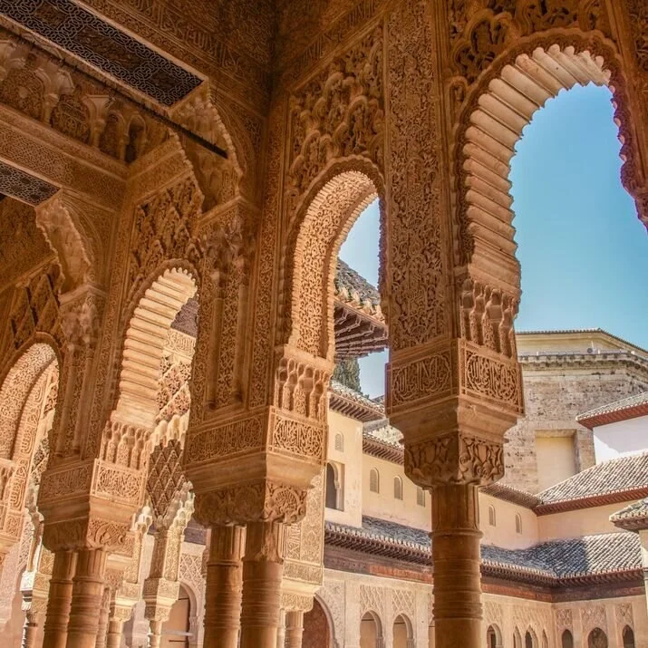 Intricately carved Moorish columns inside the Alhambra in Granada, Spain – a masterpiece of Islamic architecture and a highlight of luxury travel in Andalusia.