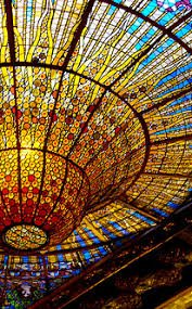 Close-up of the stunning stained-glass ceiling of the Palau de la Música Catalana, showcasing vibrant colors and intricate design.