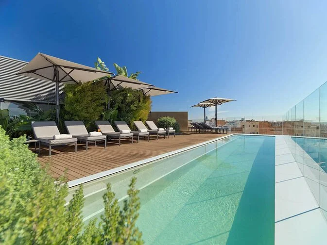 Rooftop pool and terrace at The One Barcelona, a 5-star Grand Luxury hotel in Barcelona, Spain