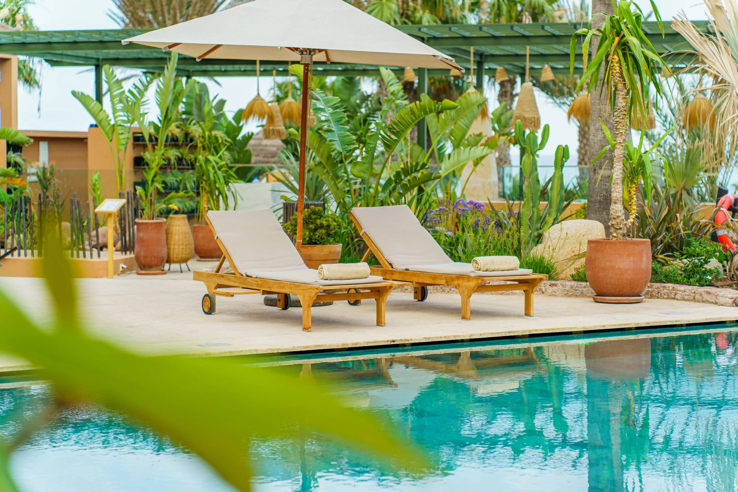 resort-poolside-sunbeds-umbrella.jpg