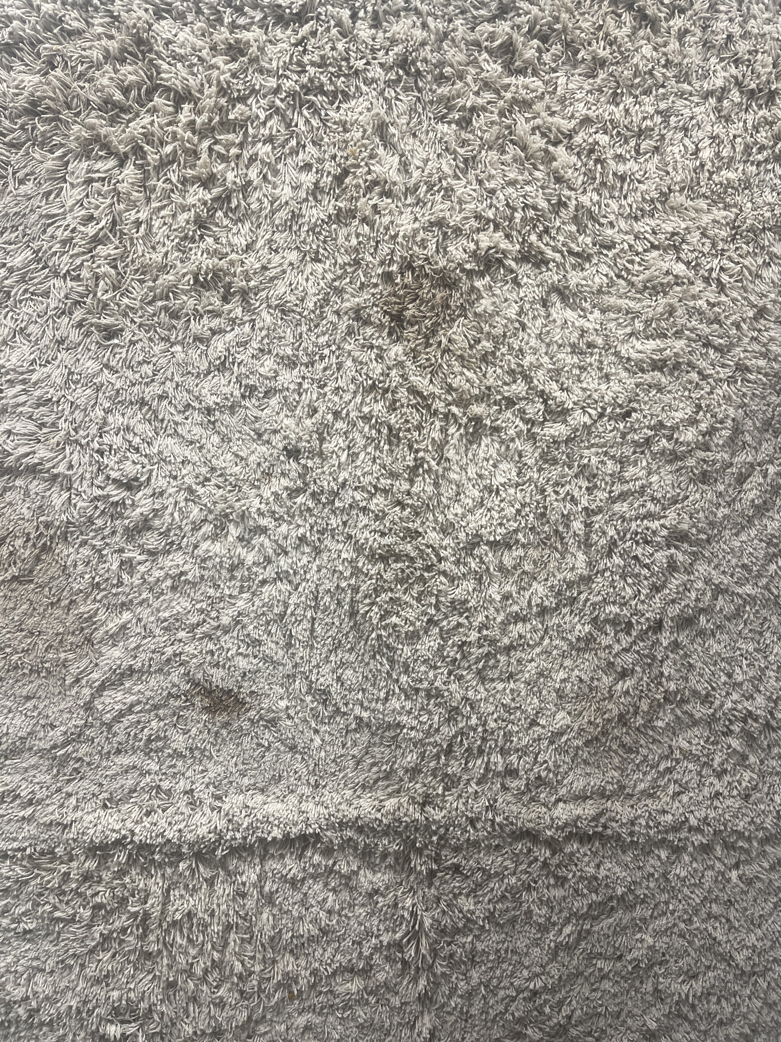 The rug that has been sitting in Papai's family home's indoor porch, unused, to be created into a desire path.