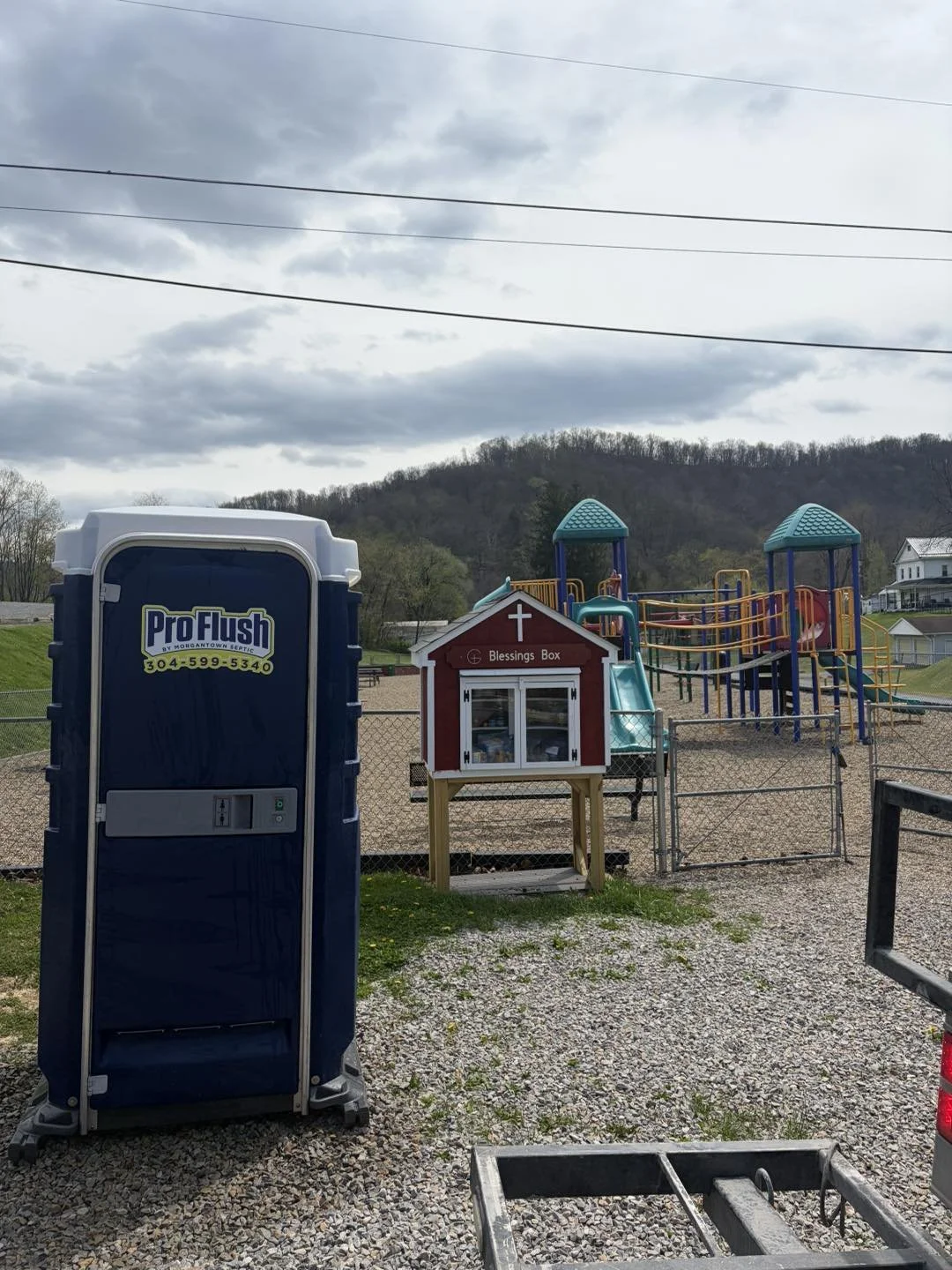 Pro Flush porta potty by playground at park
