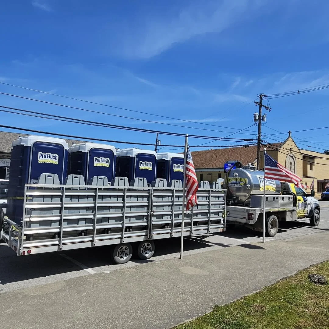 Rent potties for local parades and events - ProFlush hauling a trailing of porta potties.