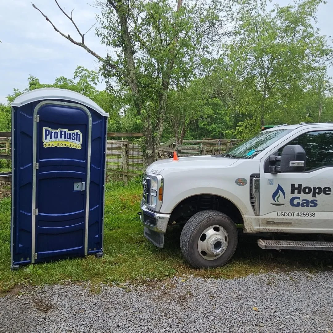 Job site porta potty rental next to Hope Gas truck