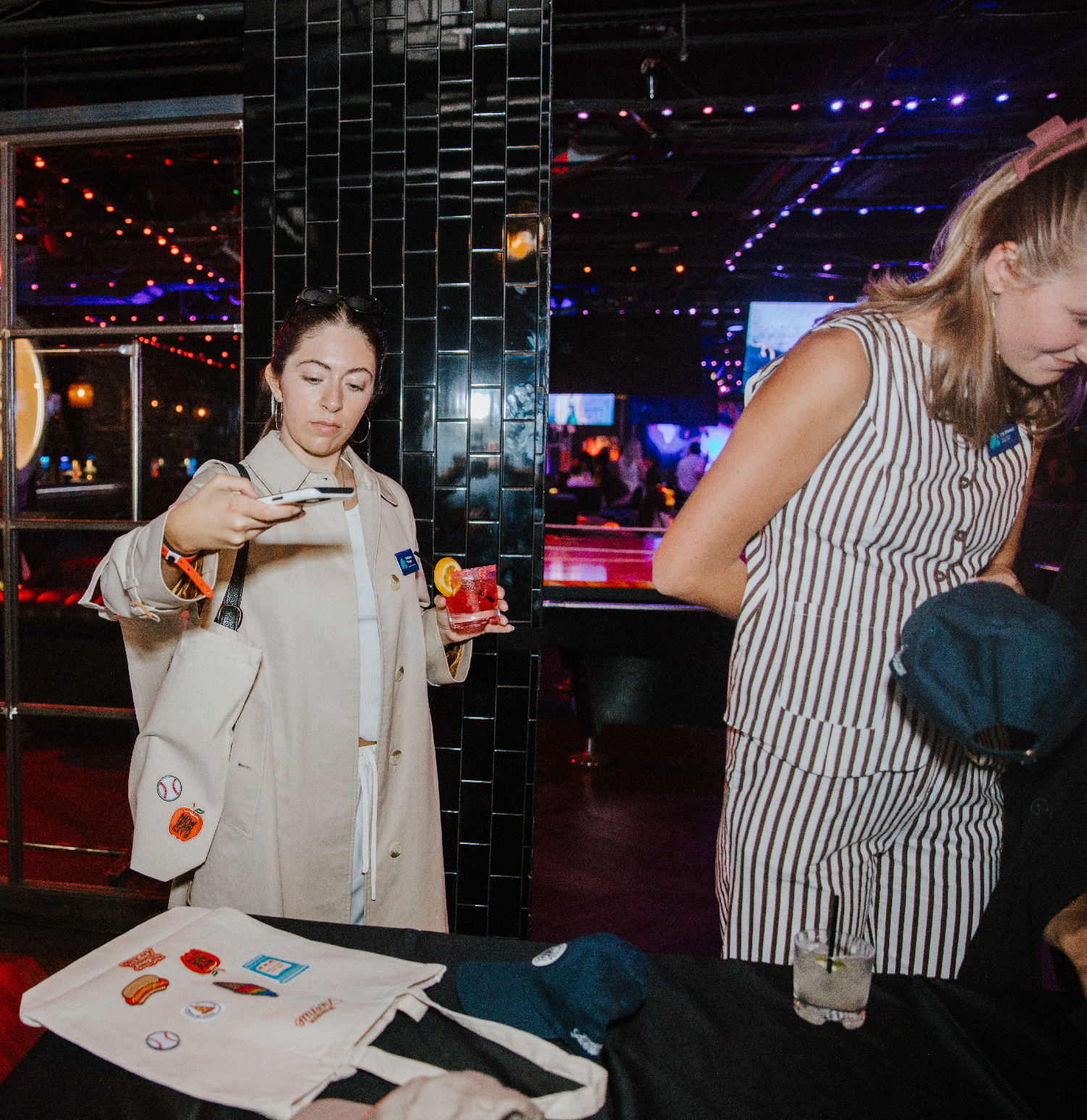 Woman taking a photo of the item she fully customized at an onsite activation, proving they have a strong ROI on social media.